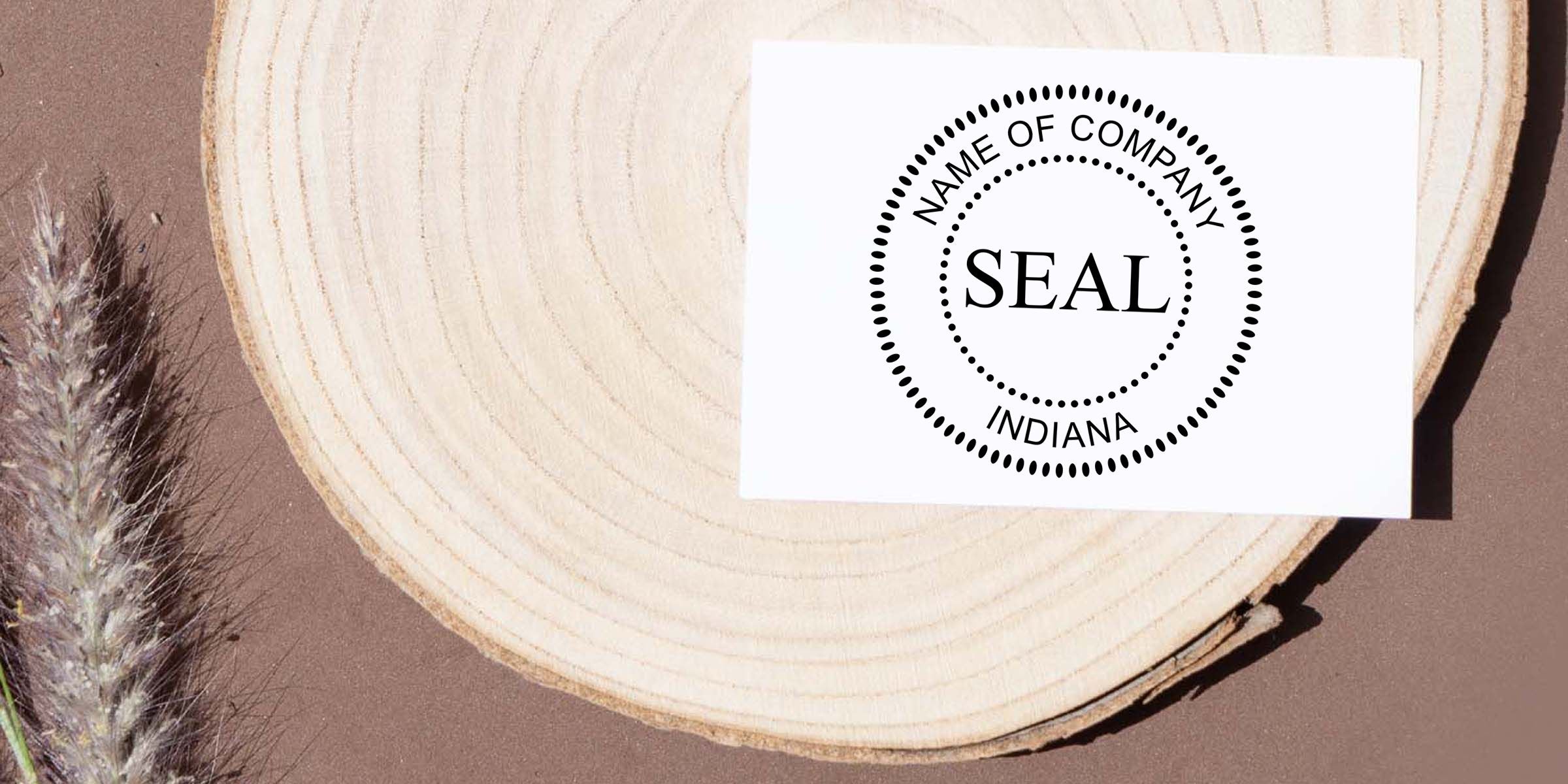 Indiana company seal template with circular dotted border on a white card, placed on a wood slice with a feather on a rustic brown background