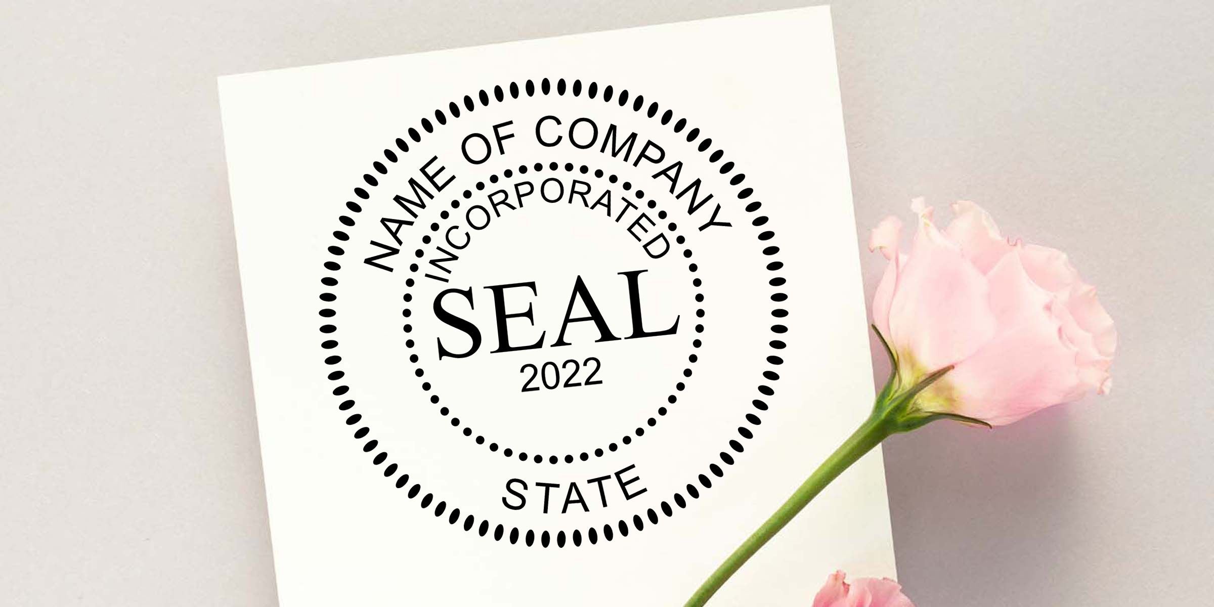 Corporate seal stamp design on white paper with “Name of Company Incorporated State 2022” text and a pink flower accent