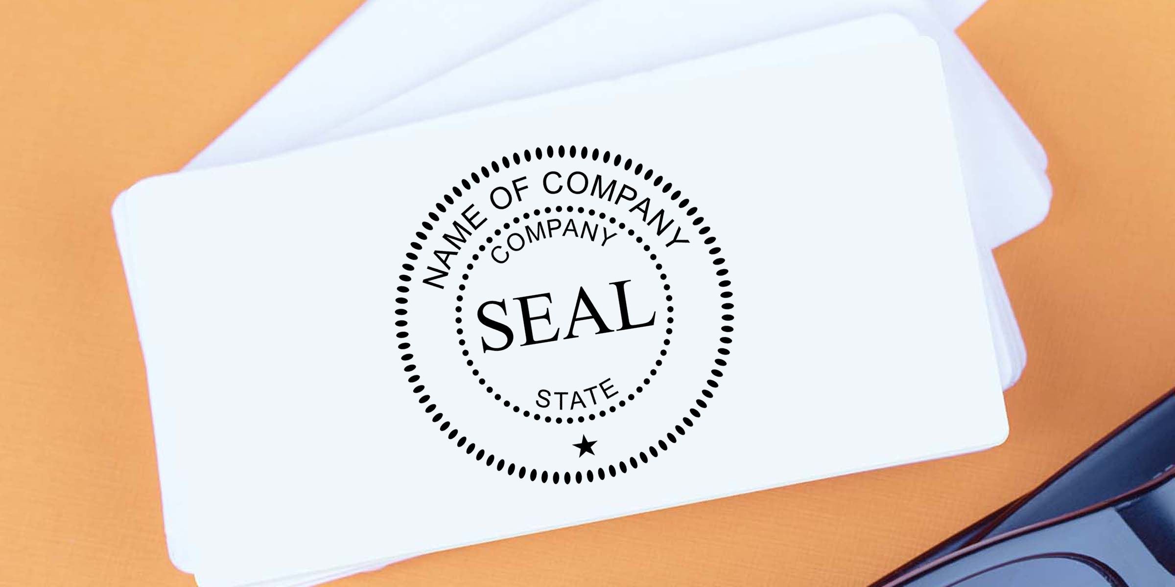 Stack of white business cards featuring a custom company seal logo with placeholder text on an orange desk background, ideal for business branding and corporate identity.