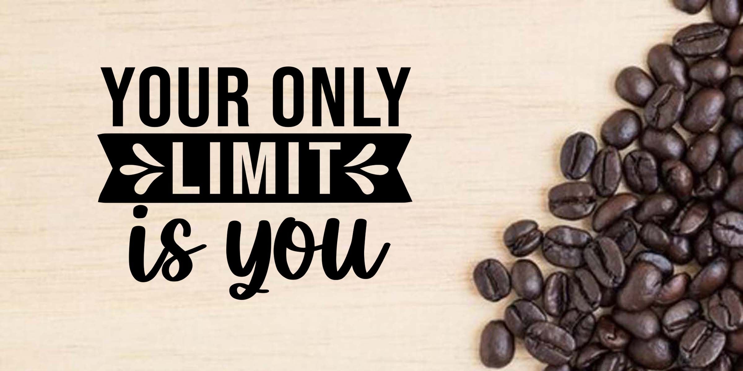 Inspirational coffee quote reading “Your only limit is you” beside roasted coffee beans on a light wooden background.
