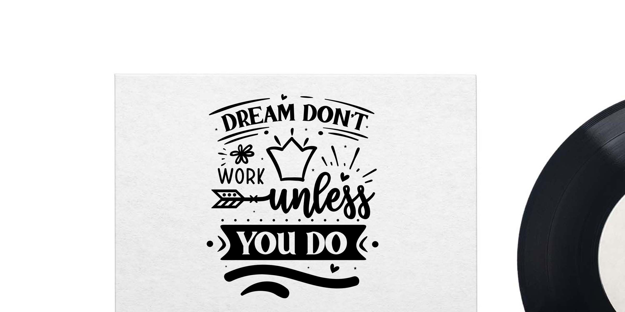 Black and white motivational wall art with the quote “Dream Don’t Work Unless You Do” and a partial vinyl record on the right side