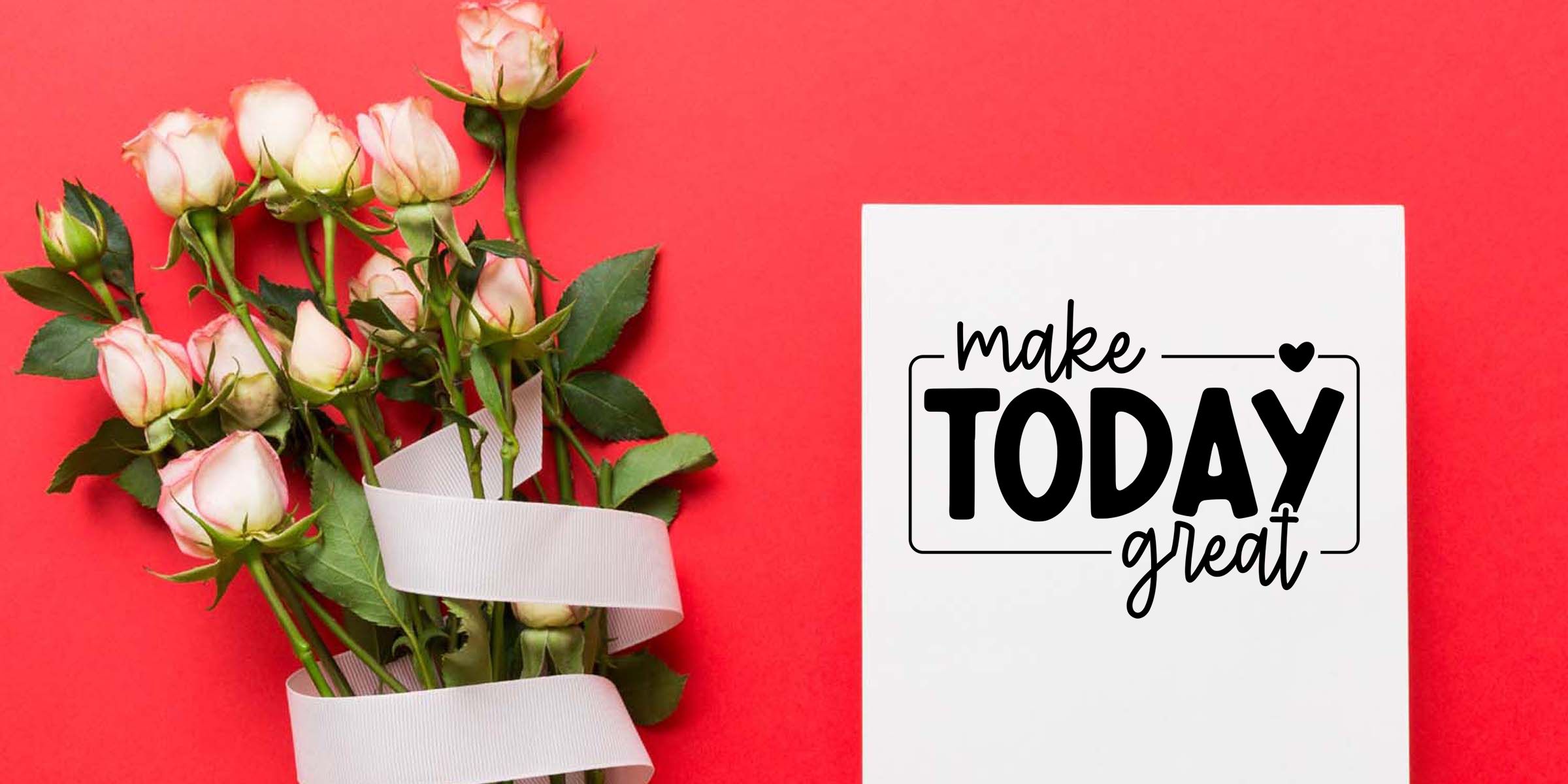 Bouquet of white and pink roses tied with ribbon beside a greeting card that reads make TODAY great on a red background
