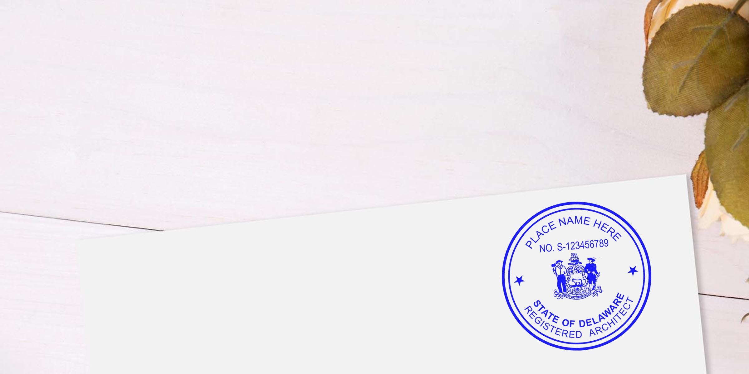 Delaware architect seal on white paper with autumn leaves on wooden table, showing Delaware architect stamp requirements and guidelines.