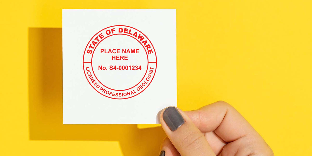 Hand holding Delaware Geologist Seal against yellow background, highlighting the seal's design guidelines.