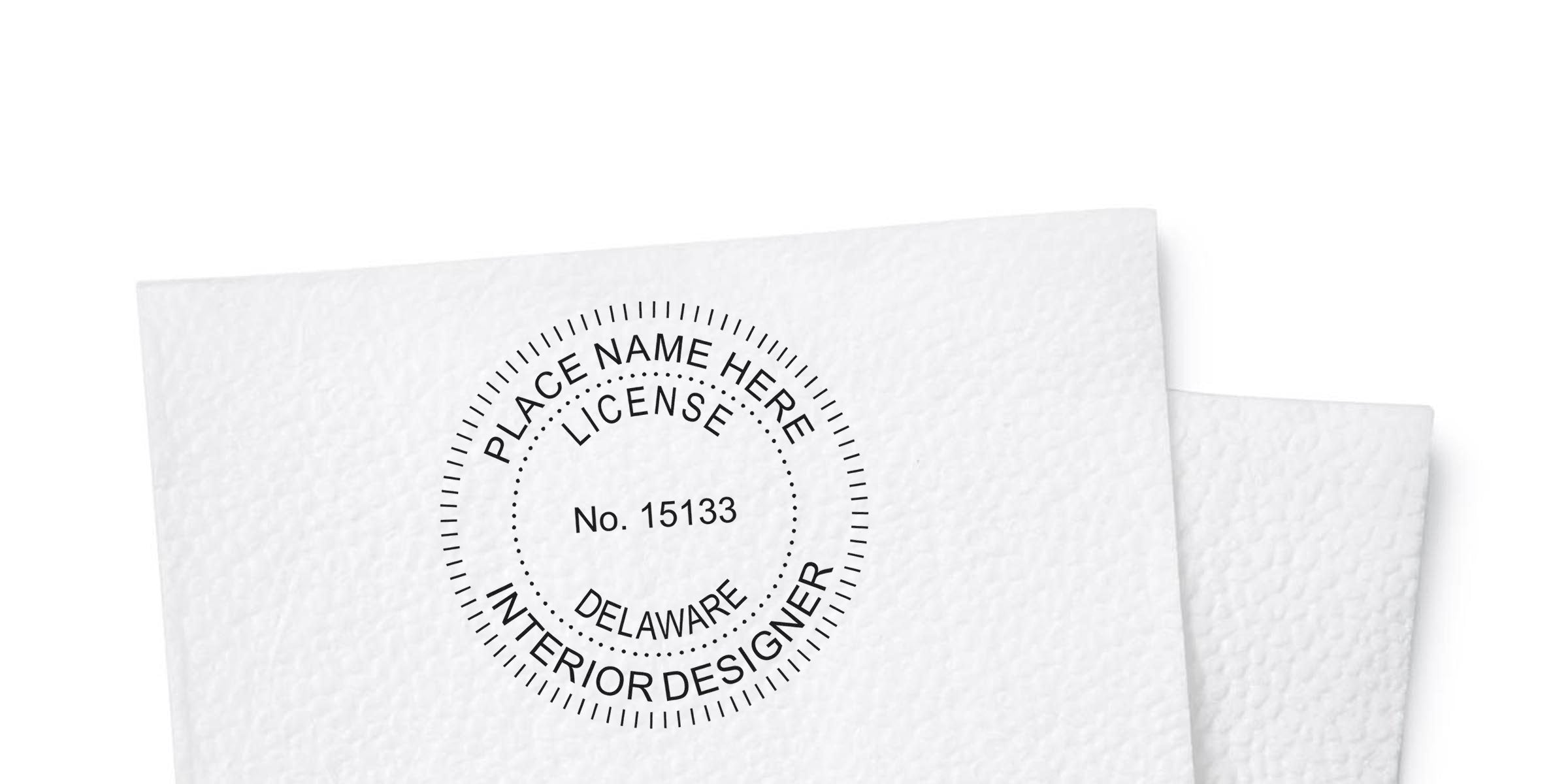 Delaware interior designer license stamp on textured white paper, fulfilling Delaware's professional interior design certification requirements.