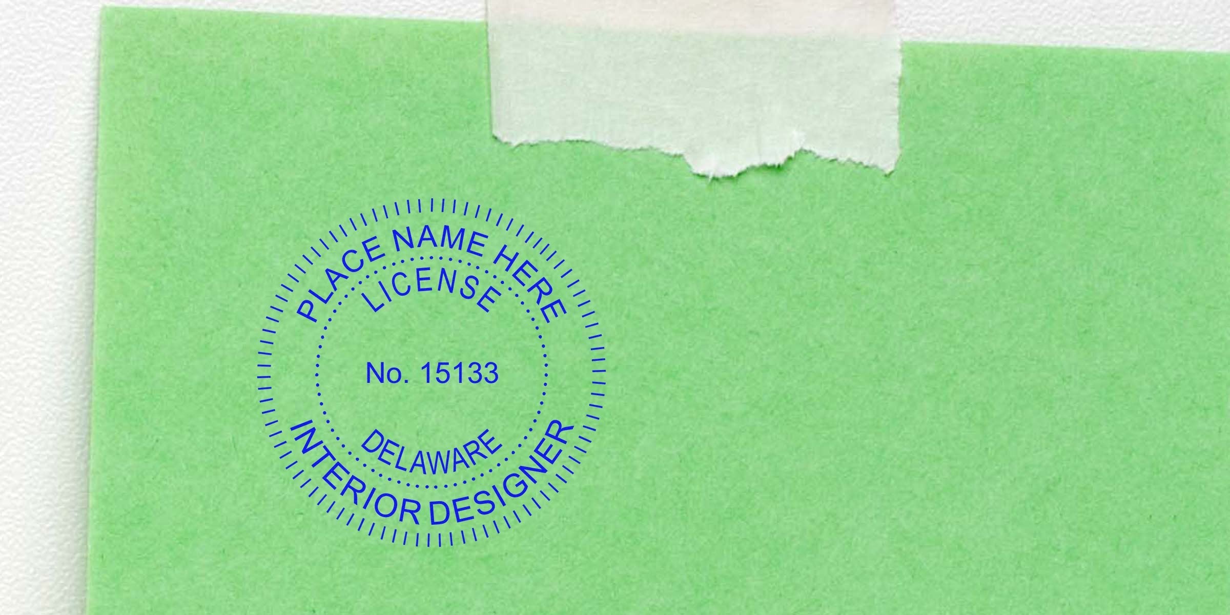 Delaware interior designer license stamp on green paper with torn tape, showing Delaware interior designer regulations and seal rules.