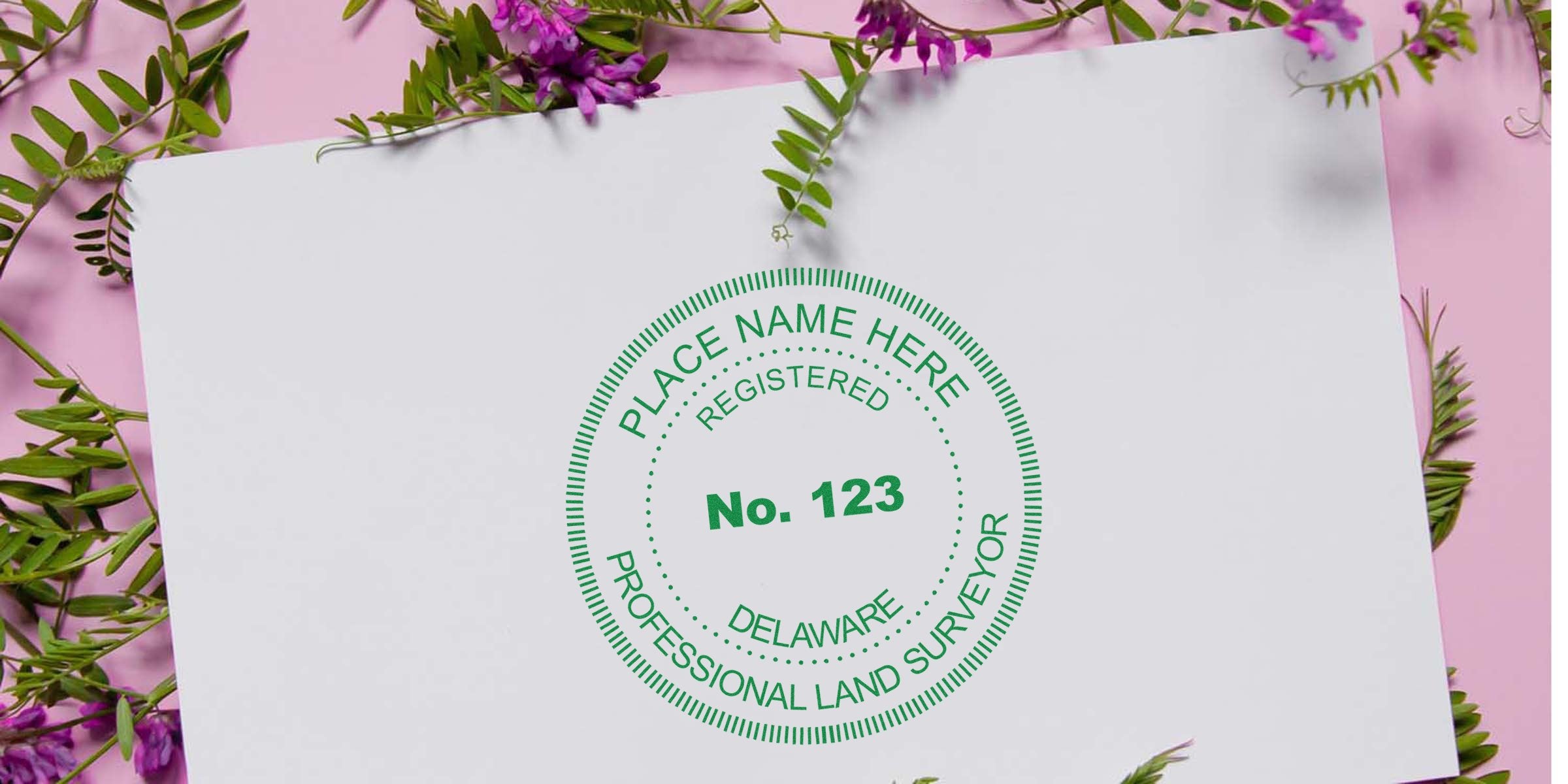 Delaware land surveyor seal embosser imprint on white paper with floral design background.