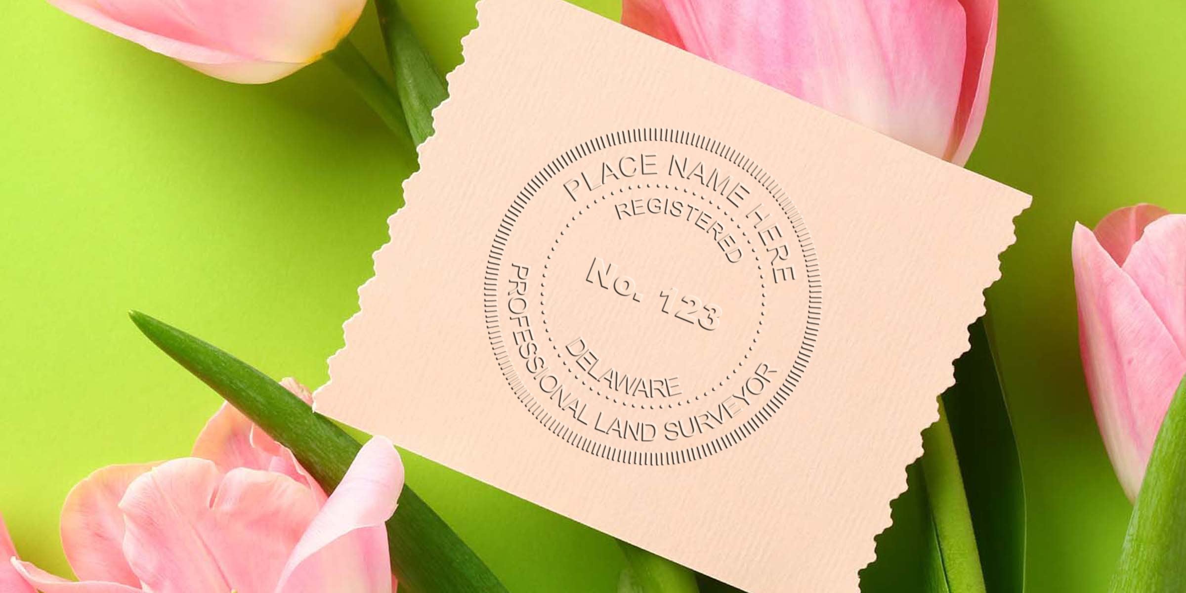 Delaware land surveyor stamp on paper, surrounded by pink tulips on a green background, emphasizing land survey compliance requirements.