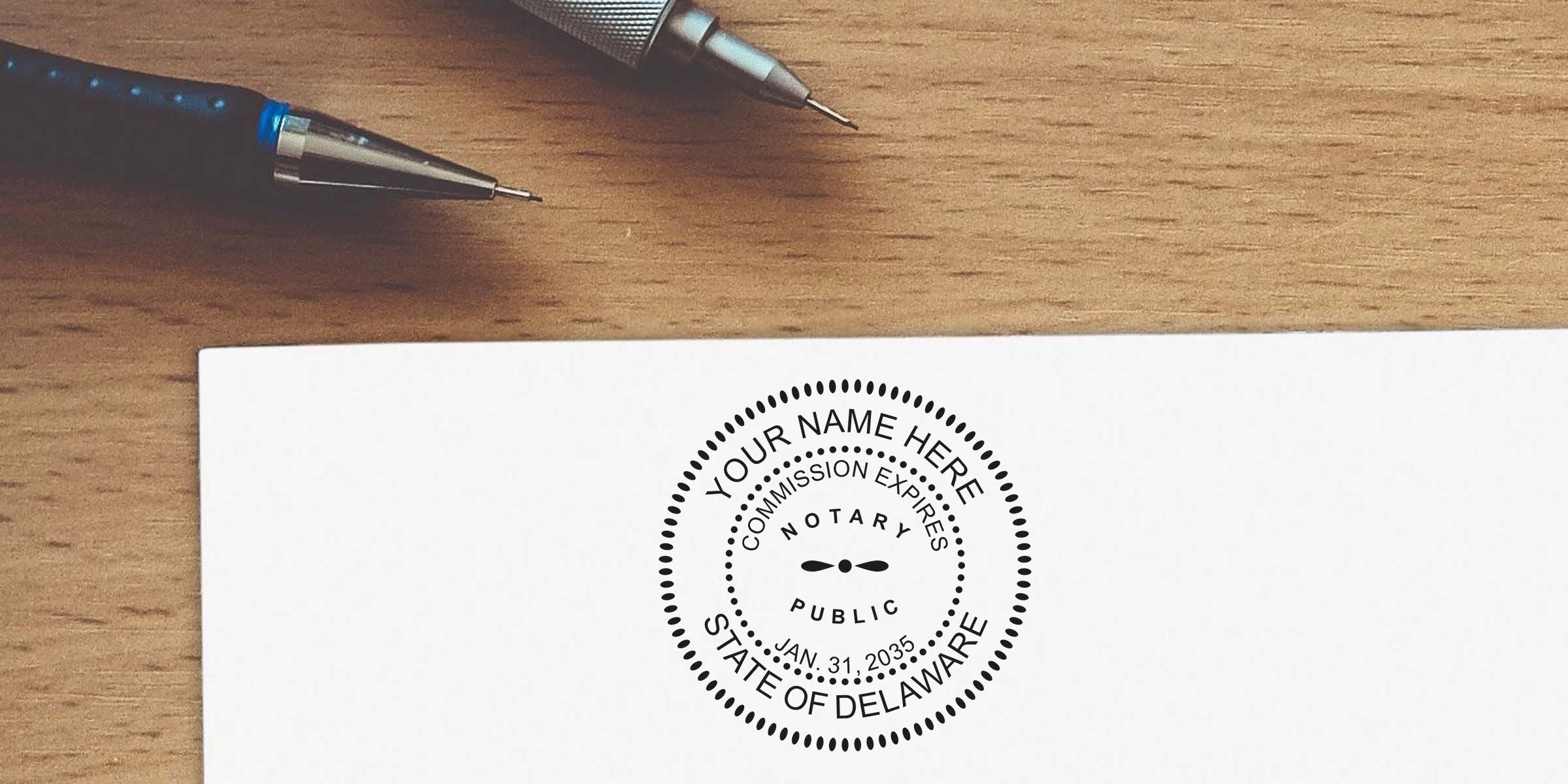 Delaware notary stamp with DE seal on white paper, pens on wooden desk, showcasing the advantages of owning a notary seal for official document verification.