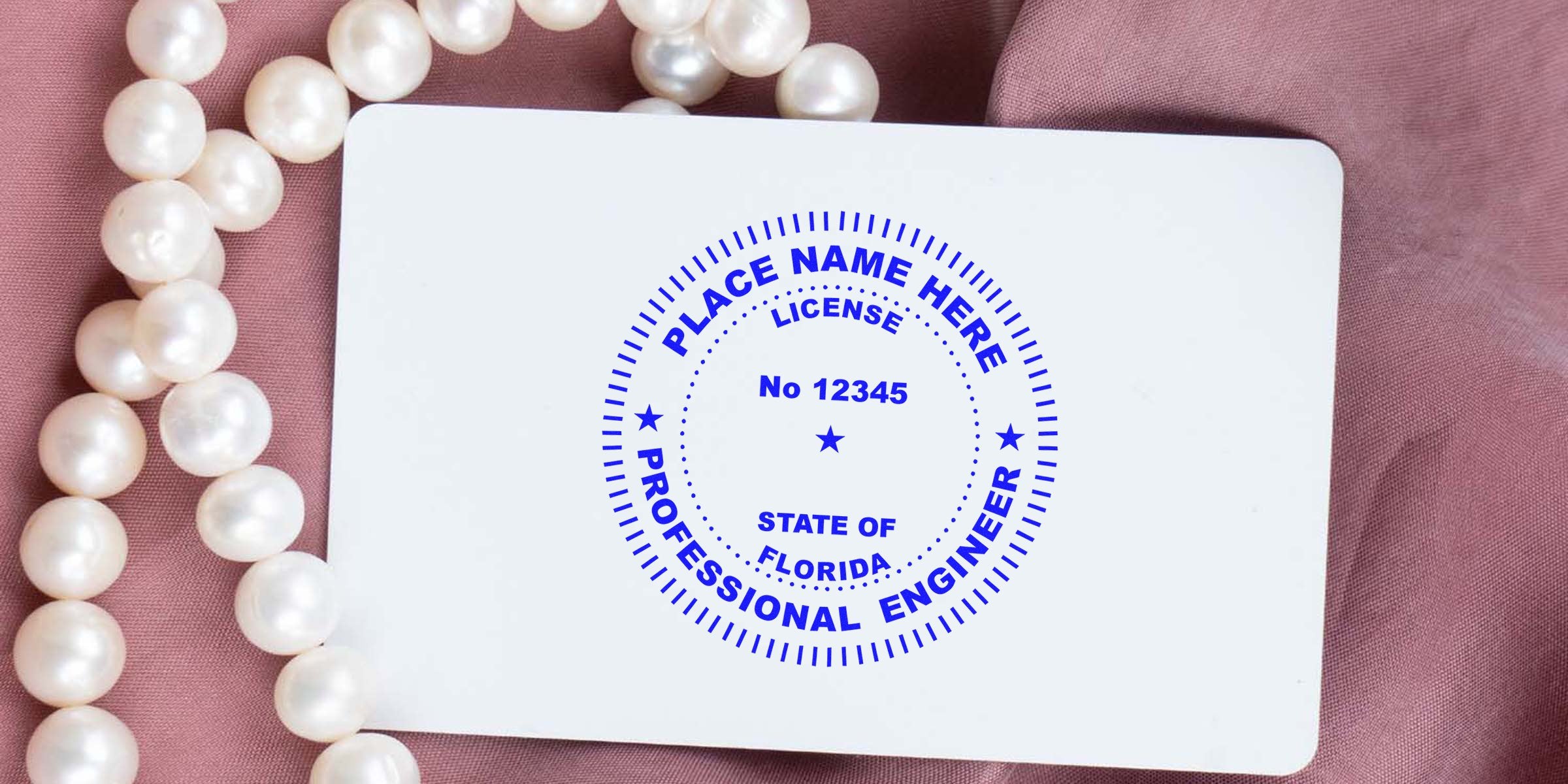 Florida engineer stamp on professional license seal shown on white card with pearl necklace and pink fabric background, emphasizing engineer stamp delivery.