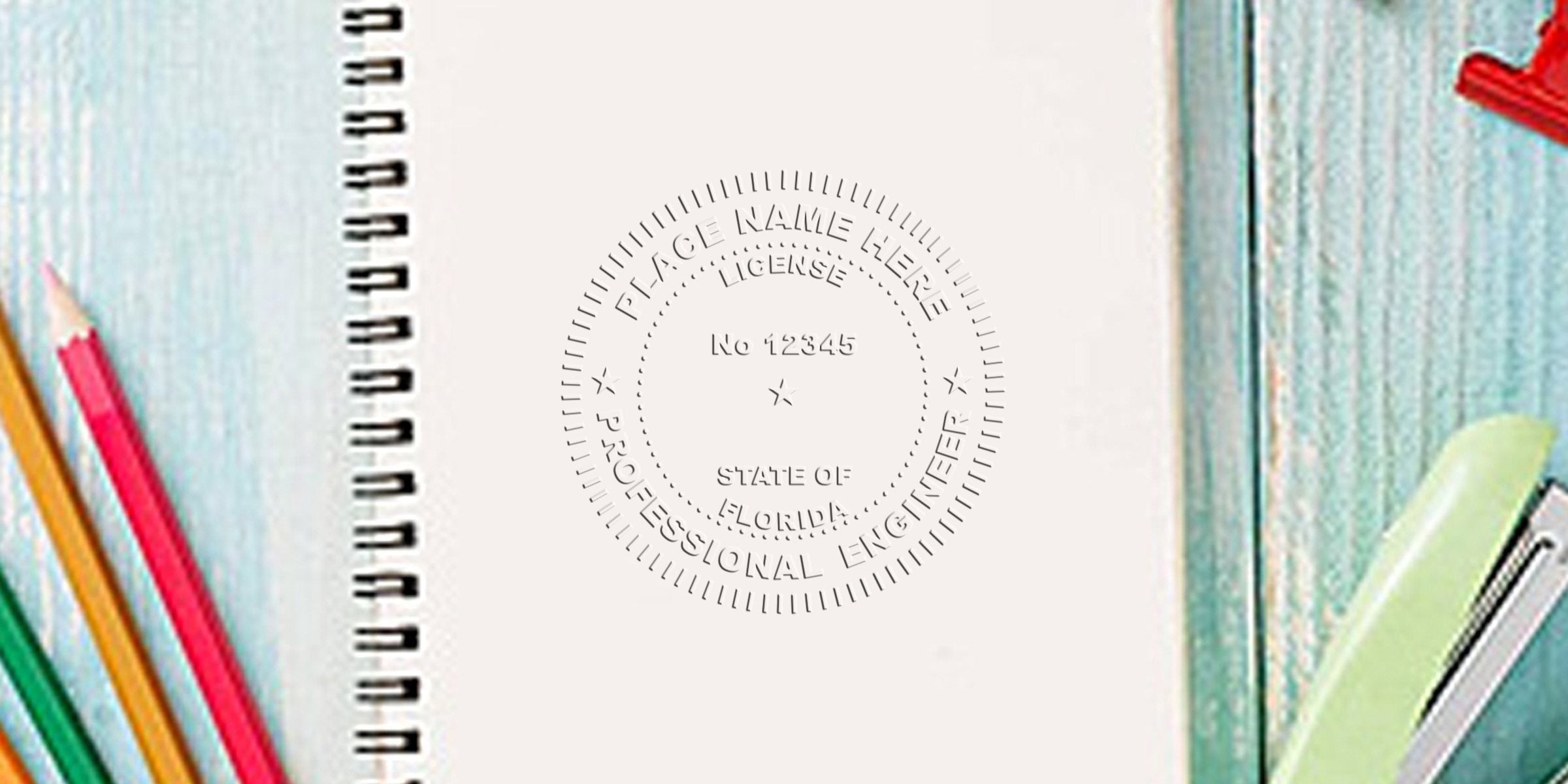 Florida engineer stamp and professional engineer seal embossed on a notebook next to colored pencils and a stapler on a wooden desk.