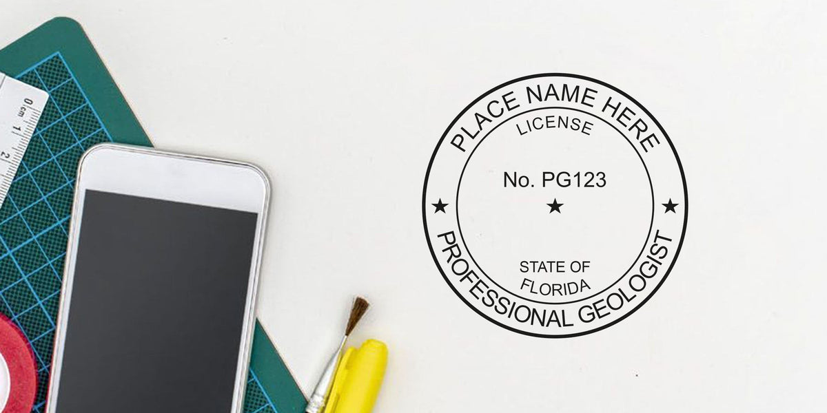 Florida geologist stamp on office desk with tools and smartphone, adhering to geologist stamp guidelines.