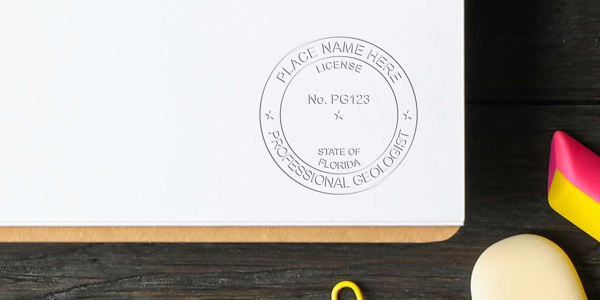 Florida Geologist Seal stamp on white paper with professional design, surrounded by office supplies on a wooden desk.