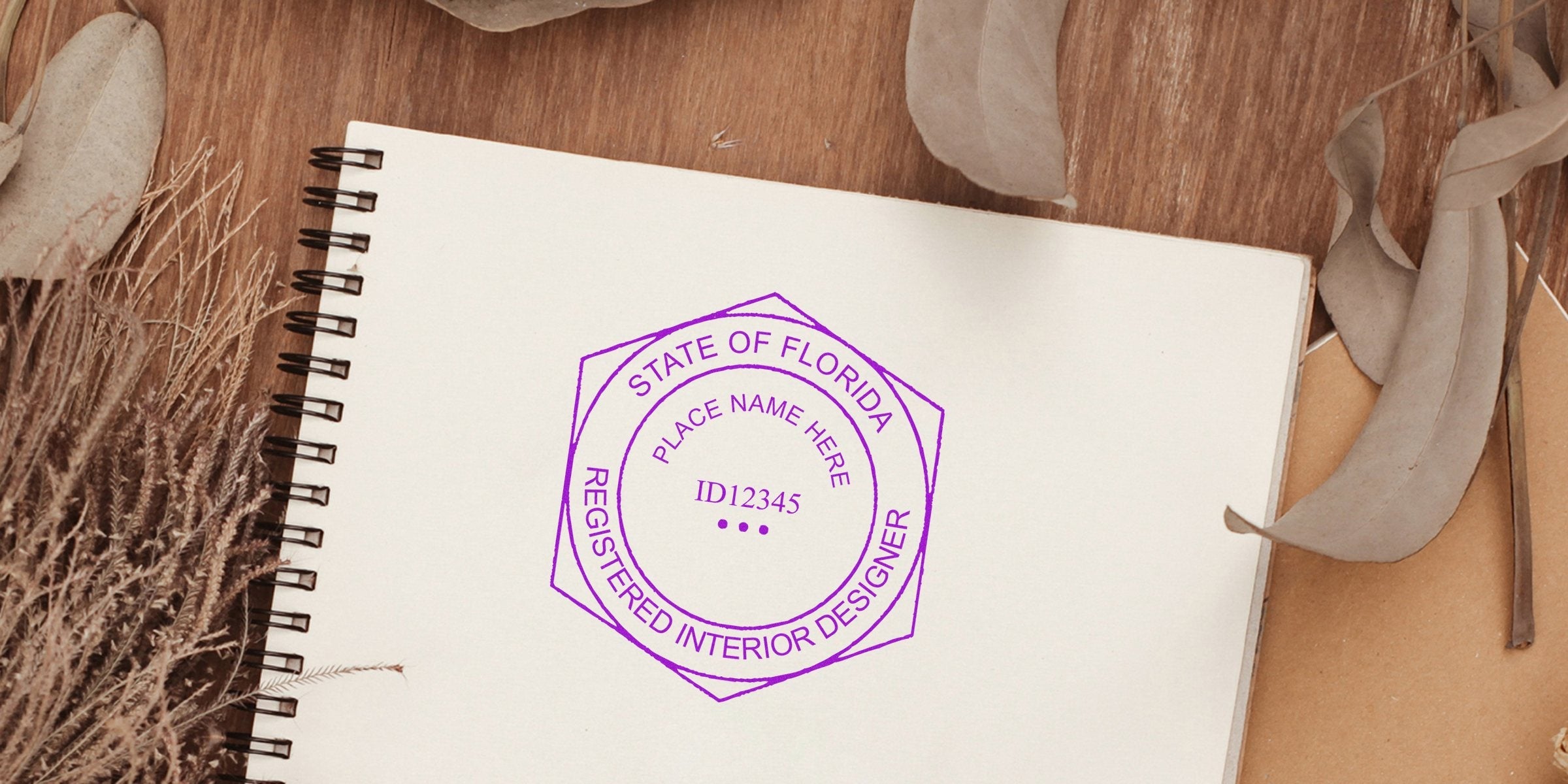 Florida Interior Designer stamp on notebook with dried leaves and rustic background, highlighting Seal Design Guidelines.