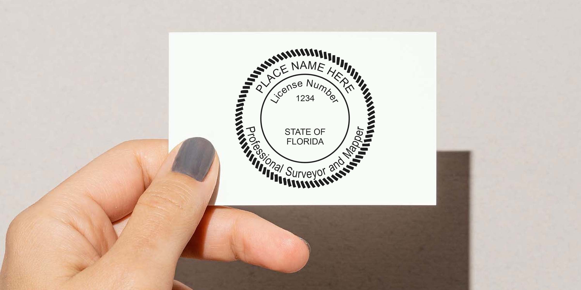 Hand holding a Florida professional surveyor license card showing the Florida land surveyor seal, meeting seal requirements, license number 1234.