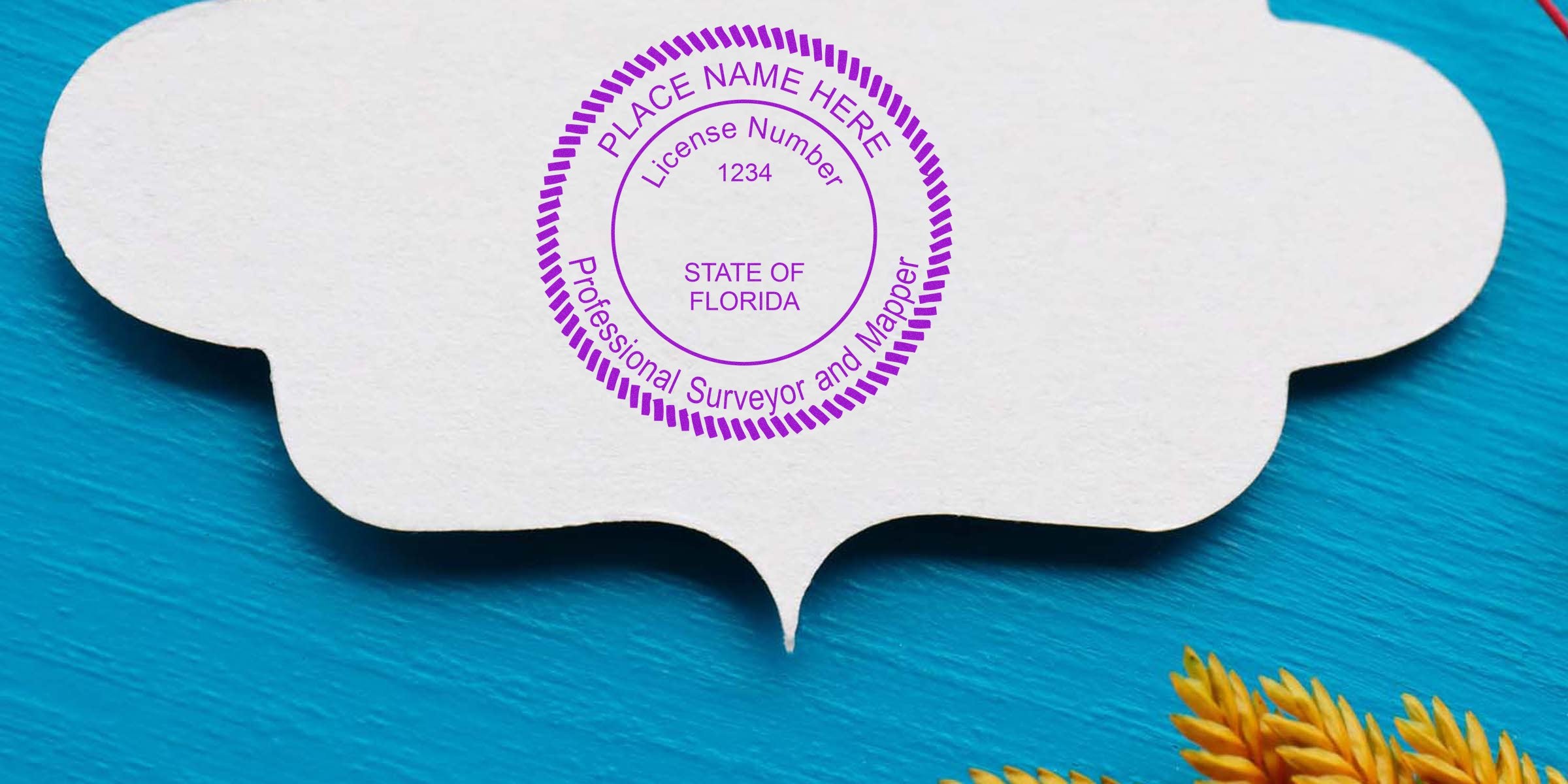 Florida land surveyor stamp on white paper with blue wood background and yellow plant, highlighting professional surveyor license and land surveyor stamp requirements.