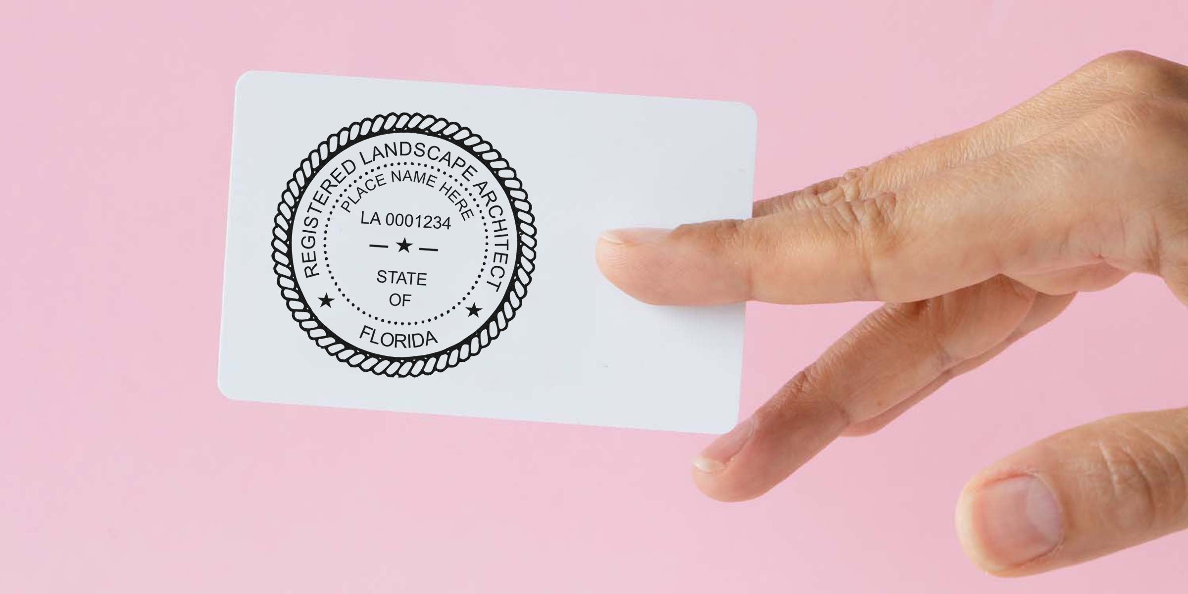 Hand holding Florida landscape architect license card displaying state certification and landscape architect stamp.