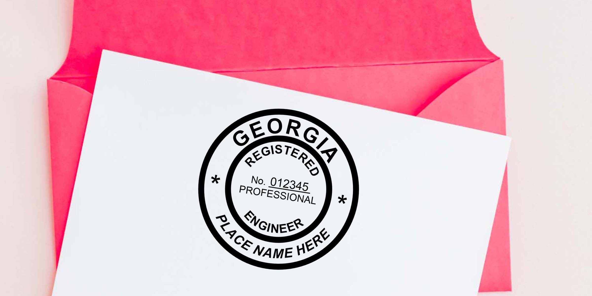 Georgia registered professional engineer stamp on white paper over a pink envelope with space for name and license number
