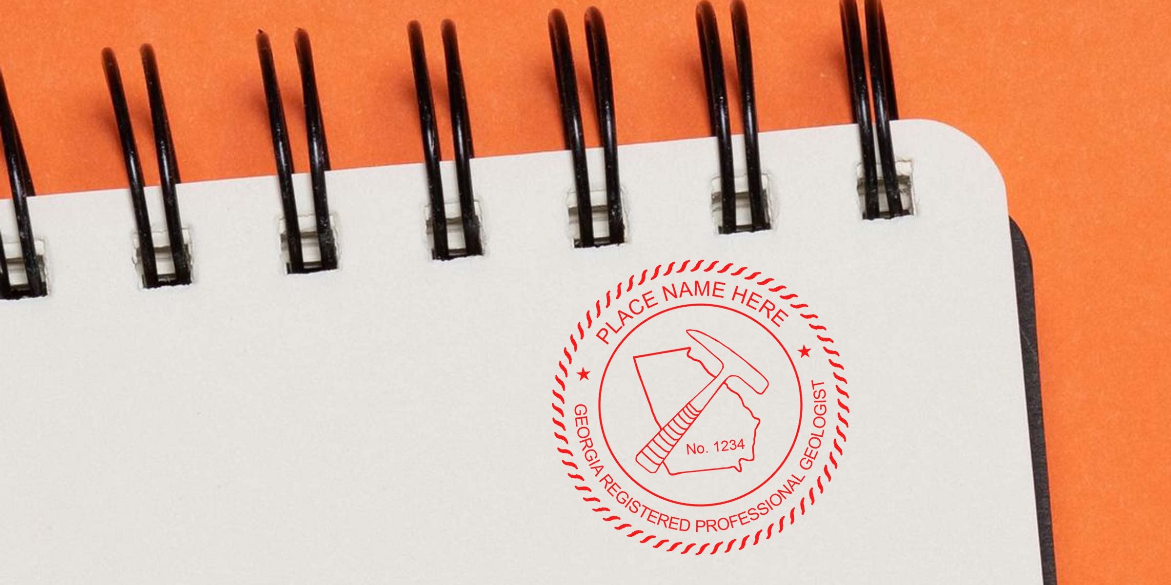 Georgia geologist stamp embossed on a spiral notebook with an orange background, showcasing the advantages of a professional embosser.
