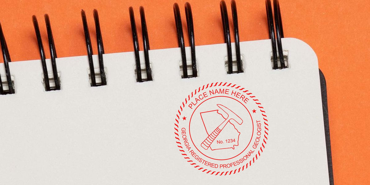Georgia geologist stamp embossed on a spiral notebook with an orange background, showcasing the advantages of a professional embosser.