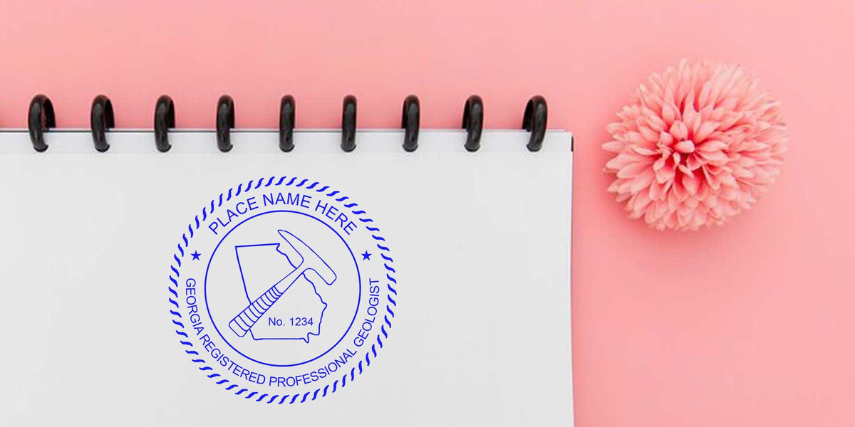 Georgia Geologist Stamp on spiral notebook with pink flower background, adhering to Geologist Stamp Guidelines.