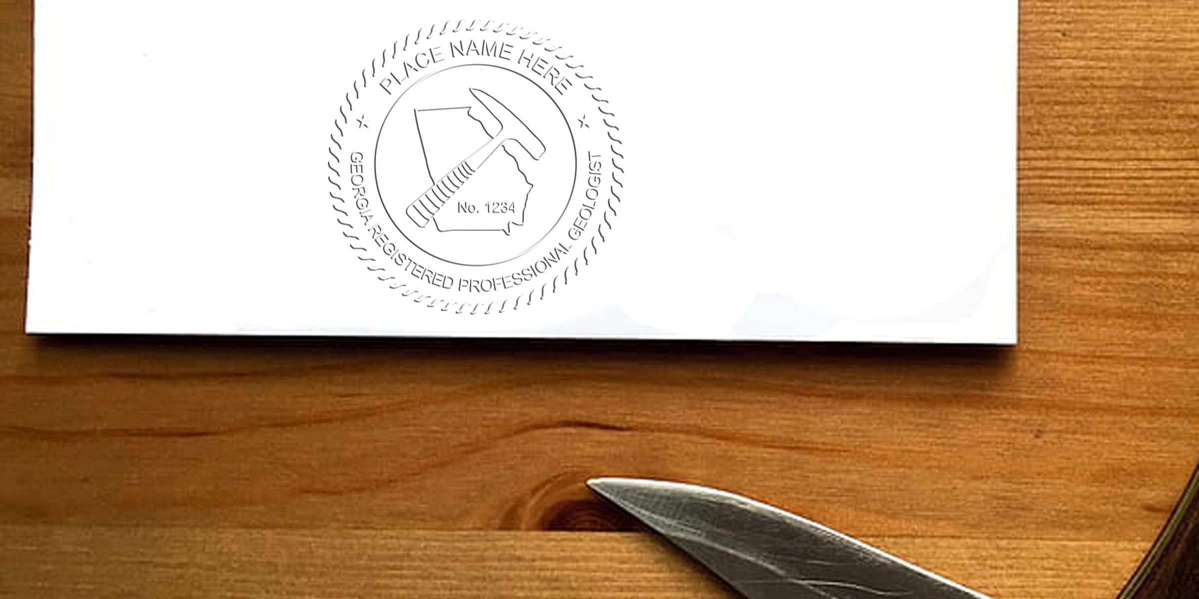 Georgia registered professional geologist embossed seal on white paper with wooden background and knife edge, showing Georgia geologist seal details.