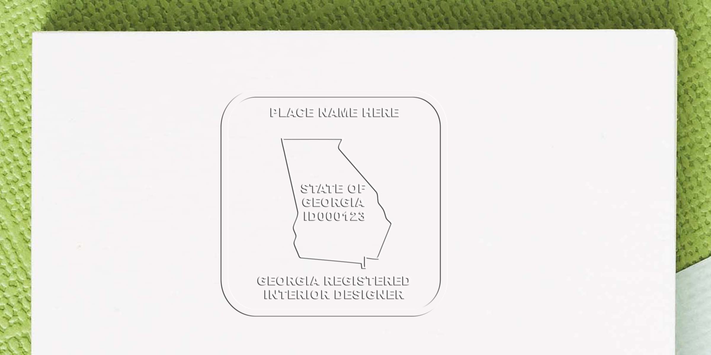 Georgia interior designer certification with embossed seal on white paper, green textured background, featuring Georgia interior designer stamp.