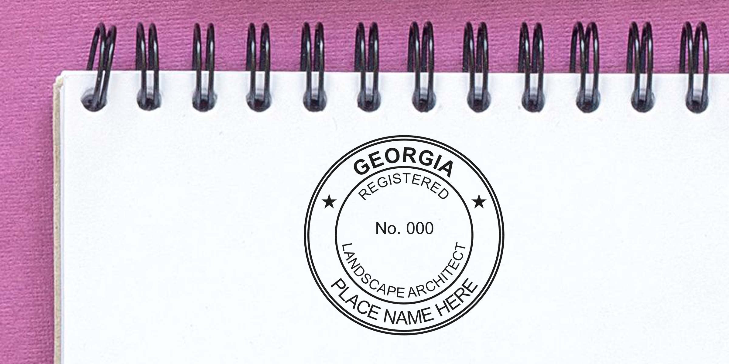 Georgia landscape architect’s registered stamp on white spiral notebook with pink background, showing seal design checklist.