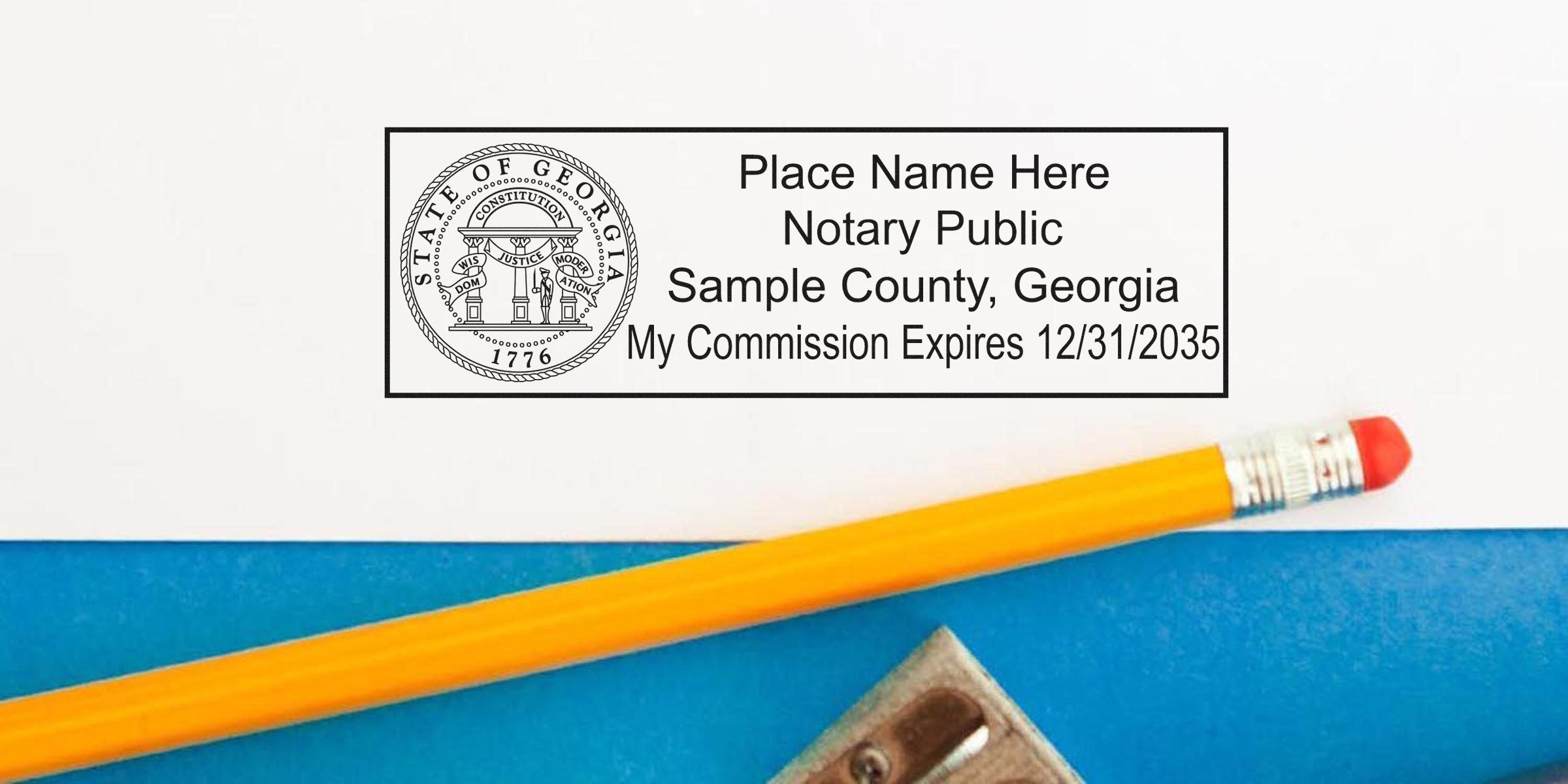 Georgia notary public commission stamp with pencil and sharpener on blue surface, displaying accurate notary seal size and seal dimensions.