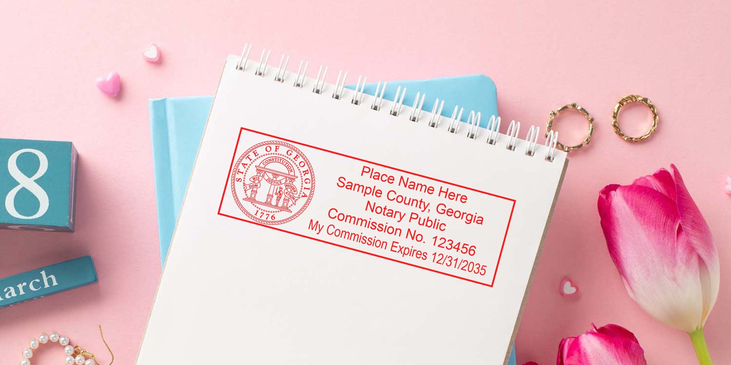 Georgia notary seal on notebook with pink tulips and March calendar block, showcasing key notary supplies in Georgia.