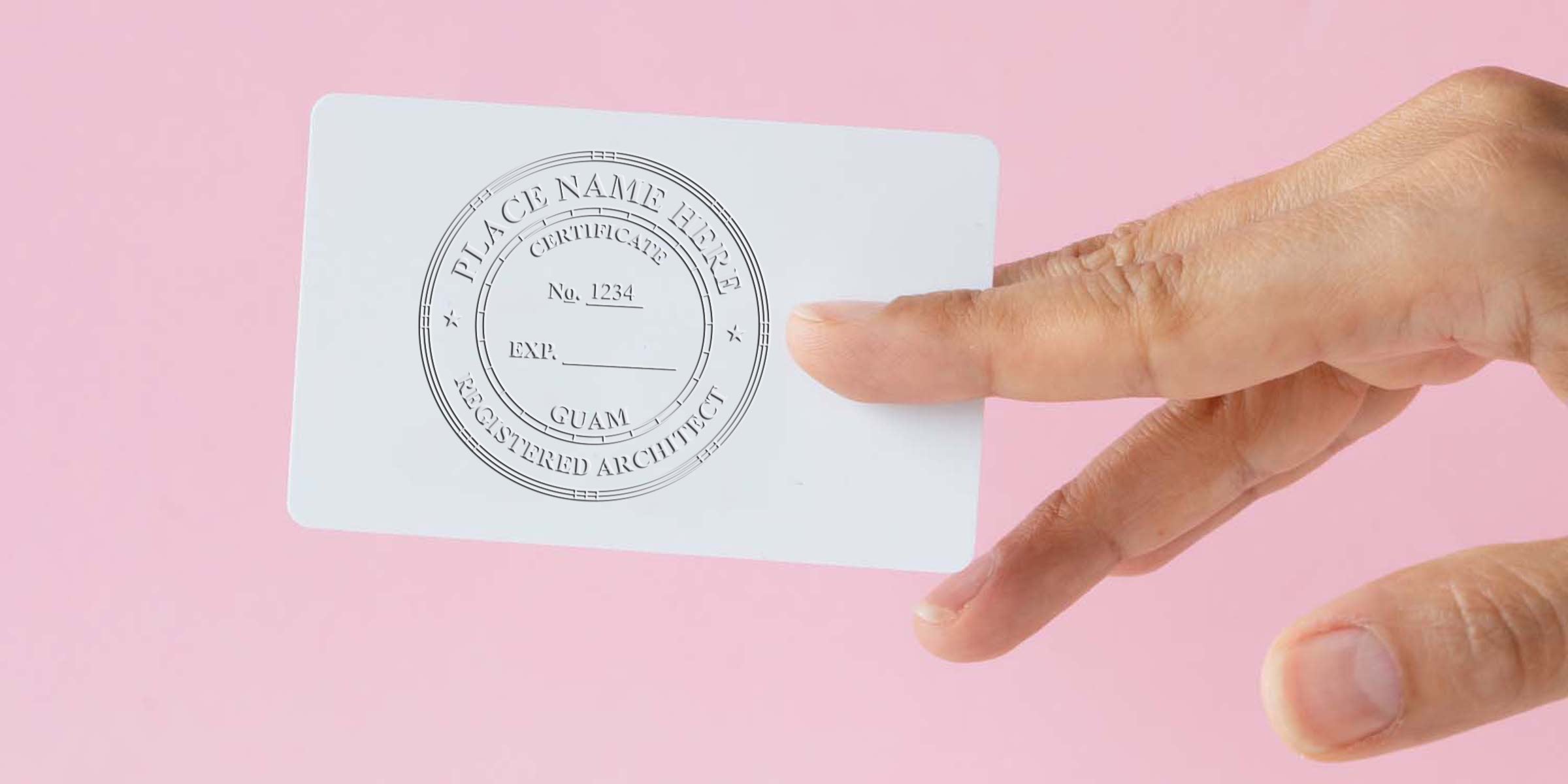 Hand holding a registered architect certificate card with the Guam architect seal on a pink background, illustrating a guide to purchasing an architect seal.