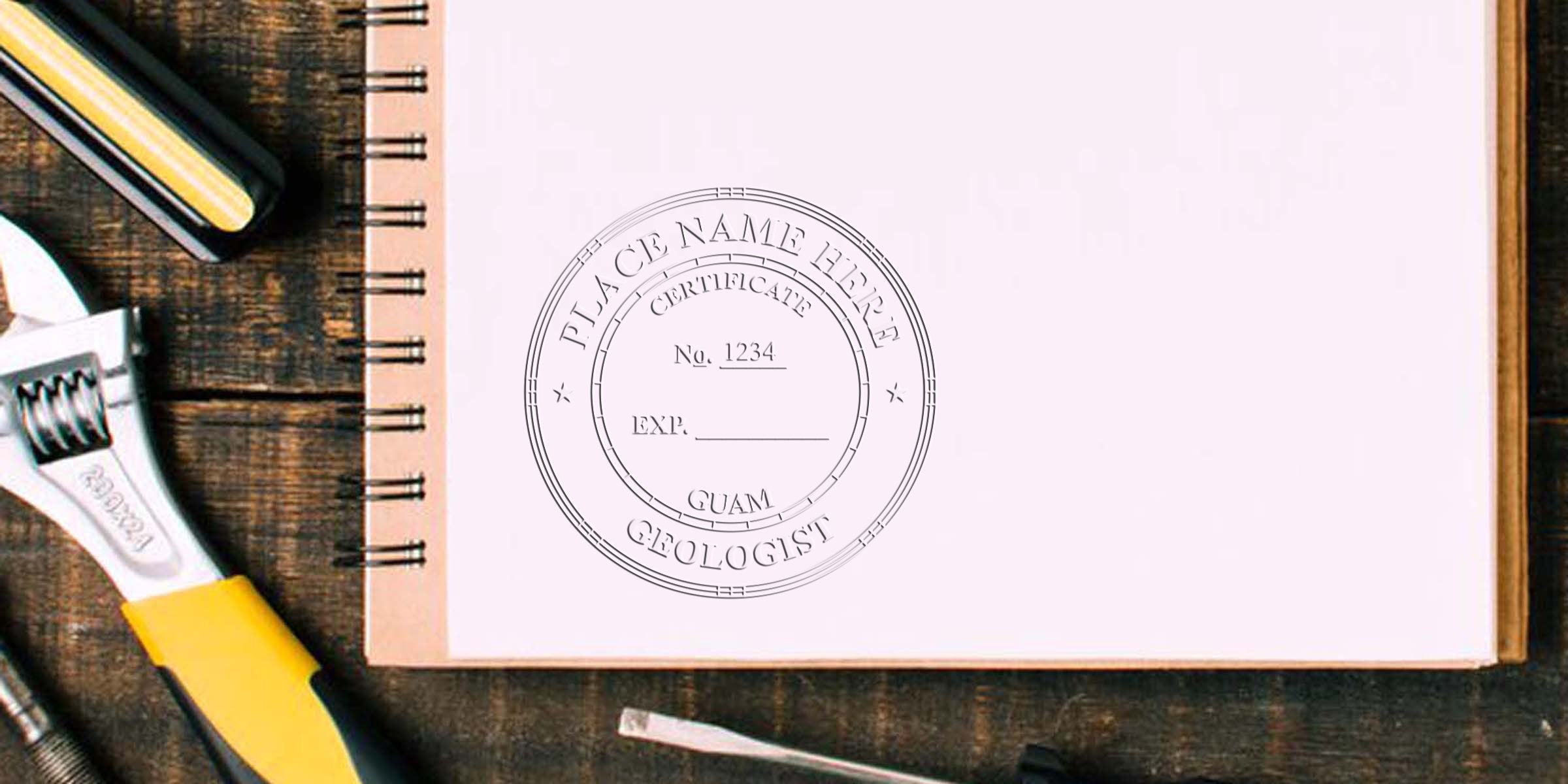 Certified Geologist Seal Guam stamp on notebook with adjustable wrench and tools on wooden table, highlighting Guam's unique geological features.