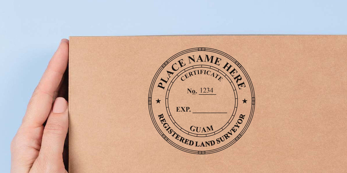 Hand holding a cardboard box with a Guam land surveyor stamp, showing a registered land surveyor certificate and details on land surveyor stamp costs.