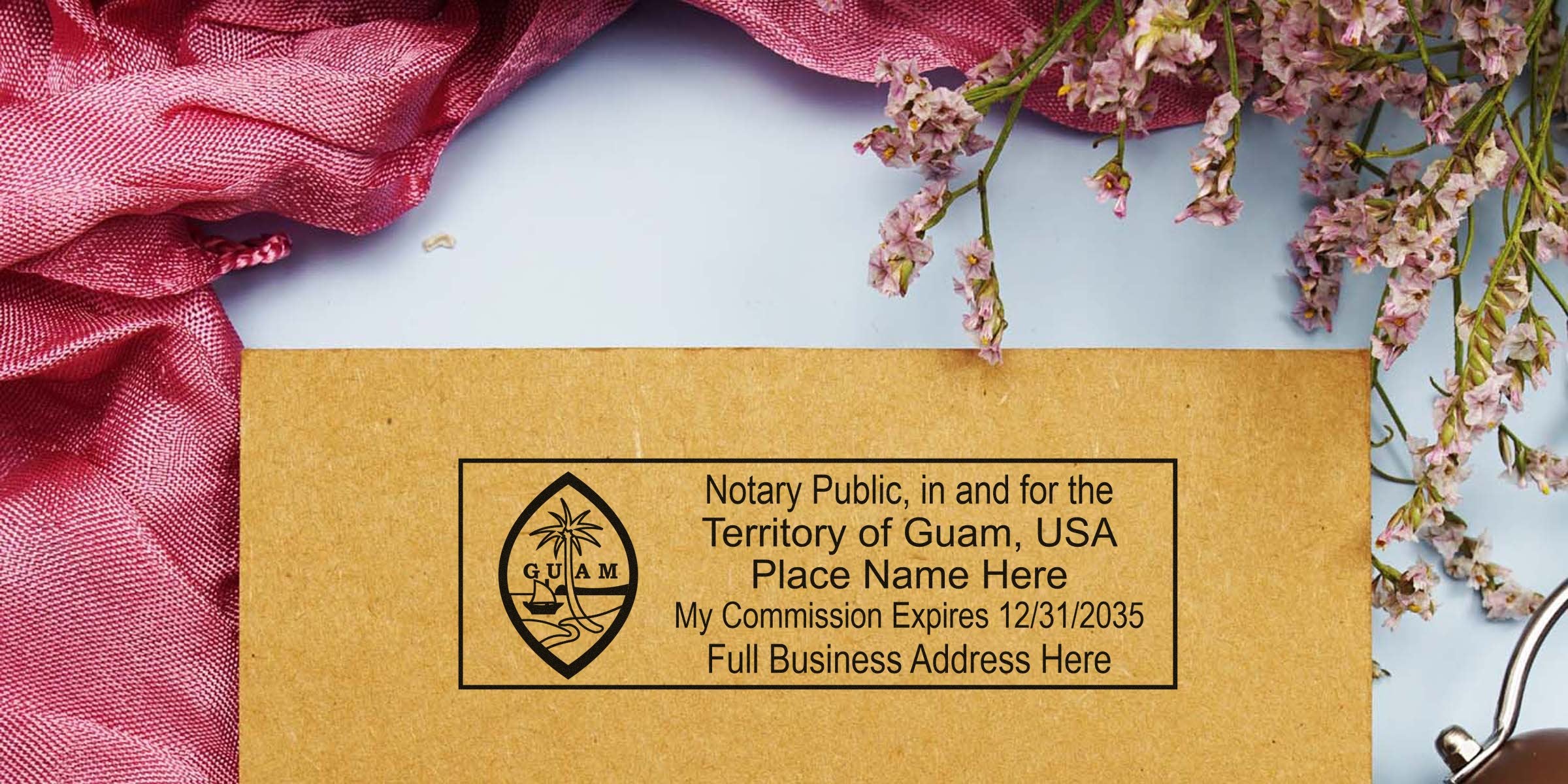 Notary Public stamp for Guam, USA on brown paper with commission expiry and business address, surrounded by pink fabric, flowers, and essential notary tools and supplies.