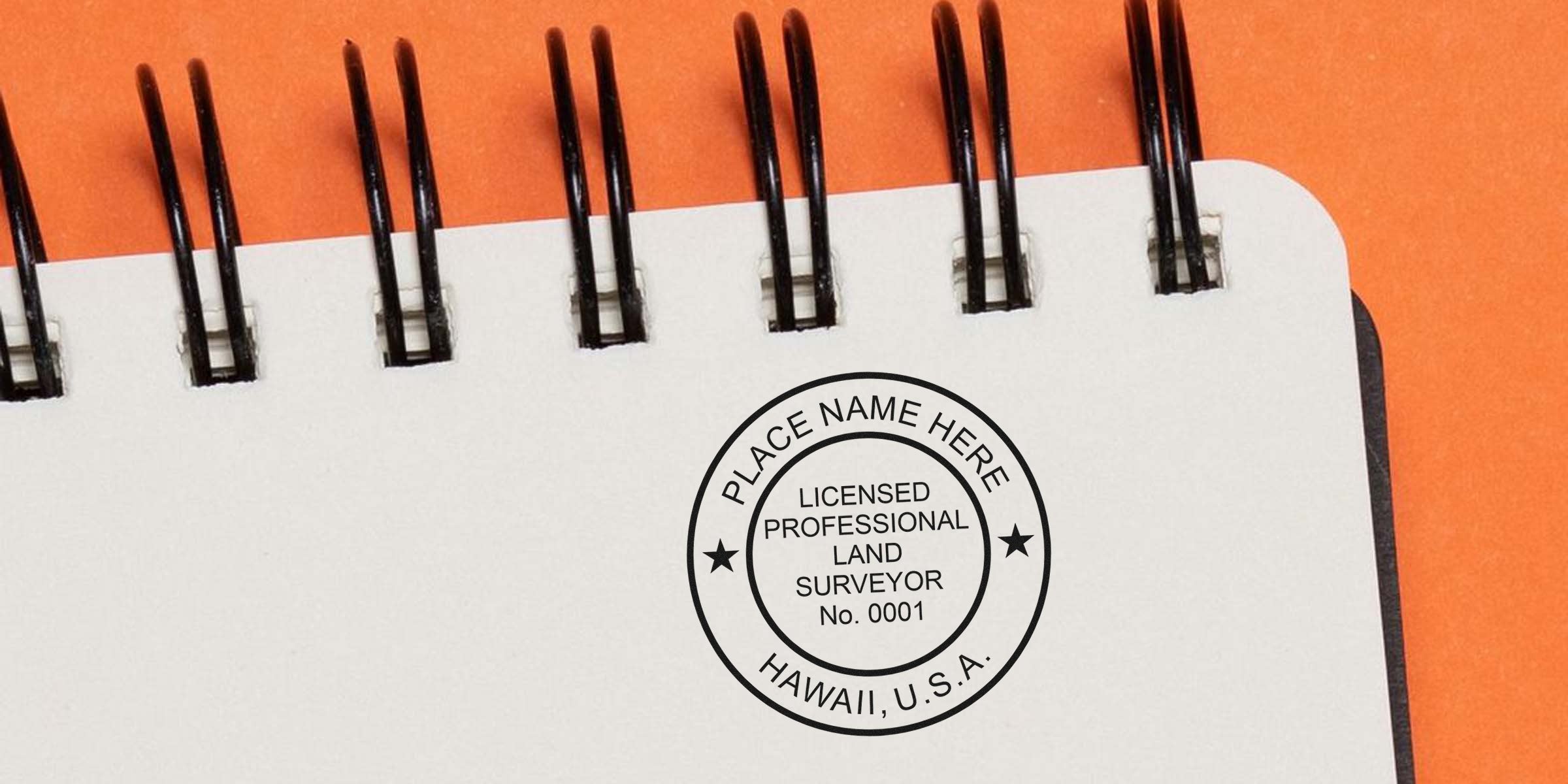 Licensed land surveyor stamp with Hawaii land surveyor and professional surveyor seals on a spiral notebook for Hawaii land surveying services.