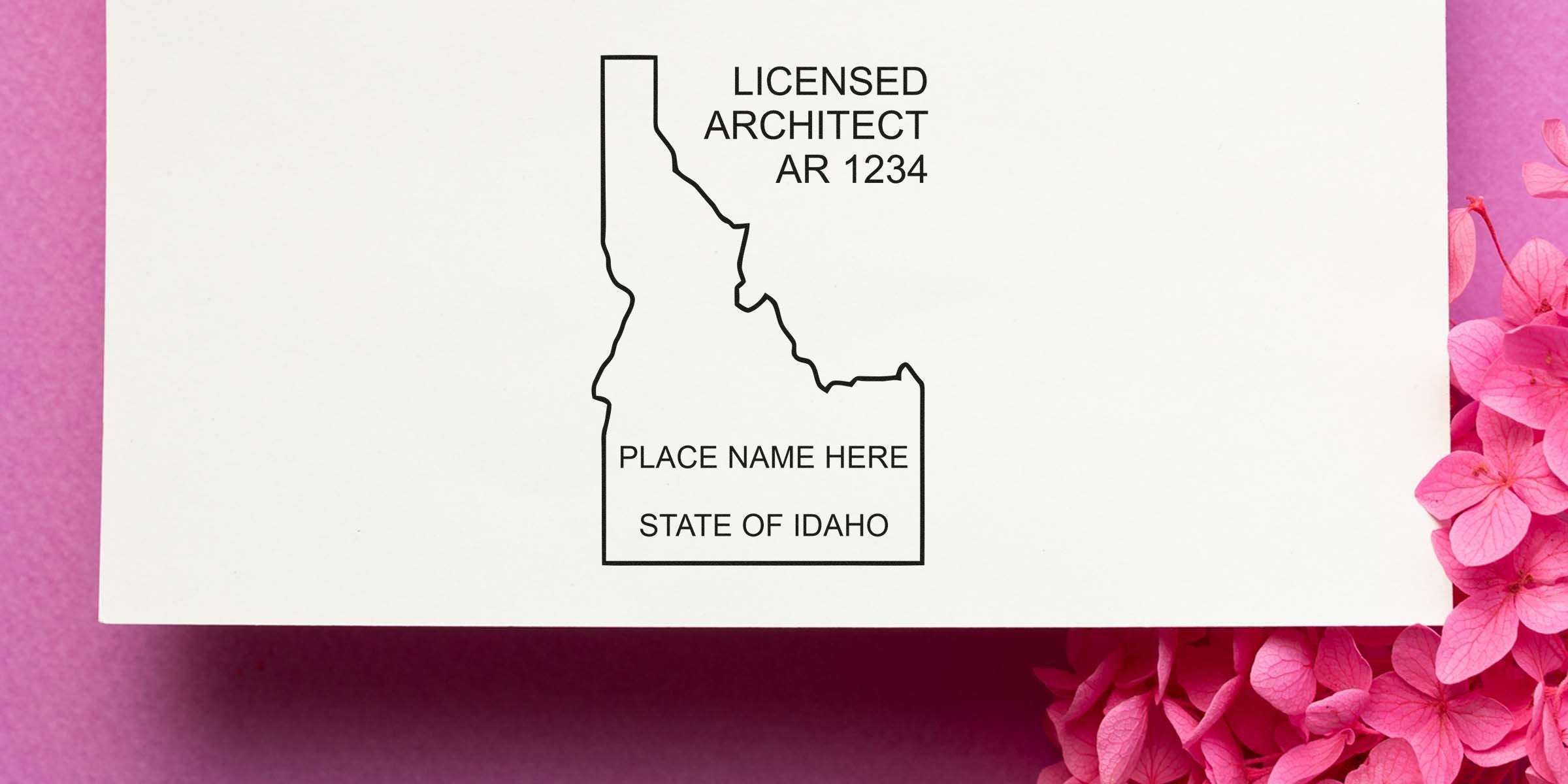 Idaho licensed architect stamp on white paper with pink flowers, showing place name, state of Idaho, highlighting architect stamp cost and value in Idaho.