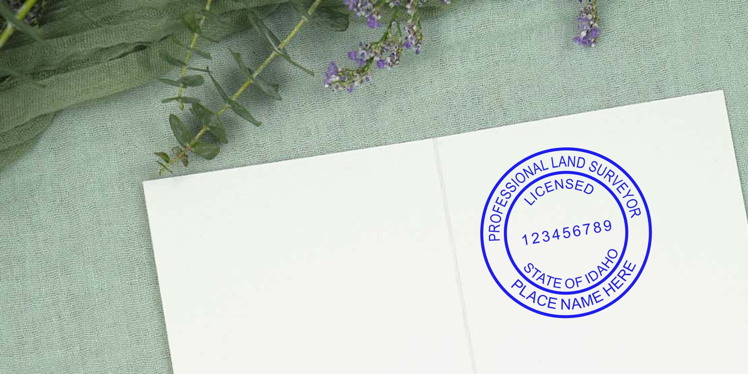 Idaho land surveyor seal stamped on white paper, set against green fabric and purple flowers, displaying professional land surveyor seal samples.