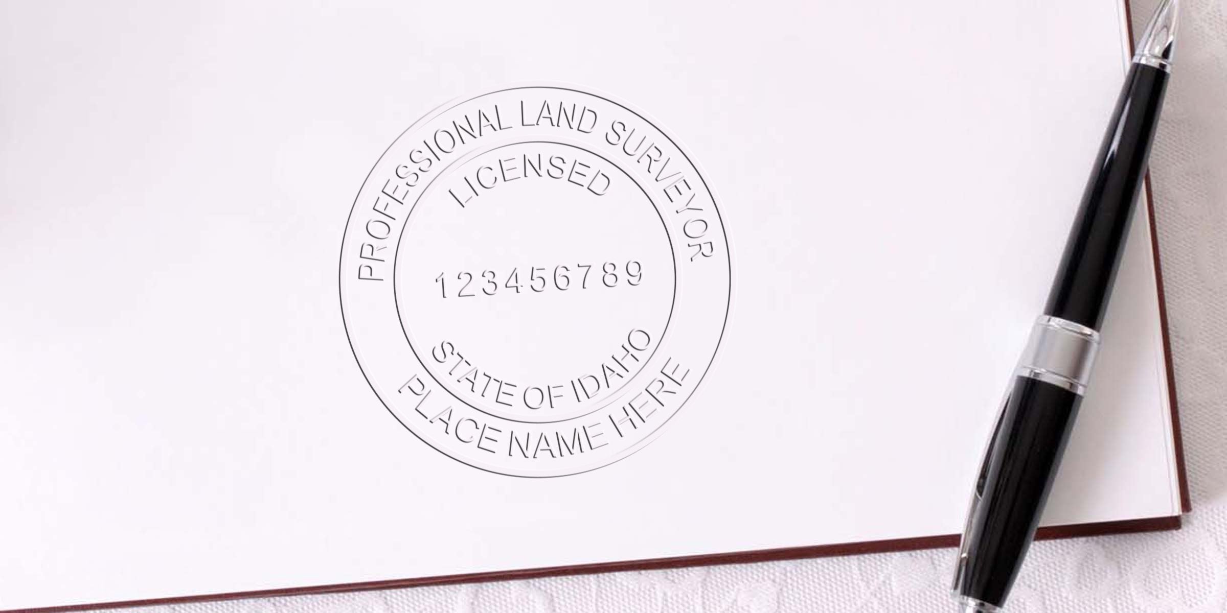 Professional land surveyor stamp with Idaho seal and pen on white paper for land surveying services.