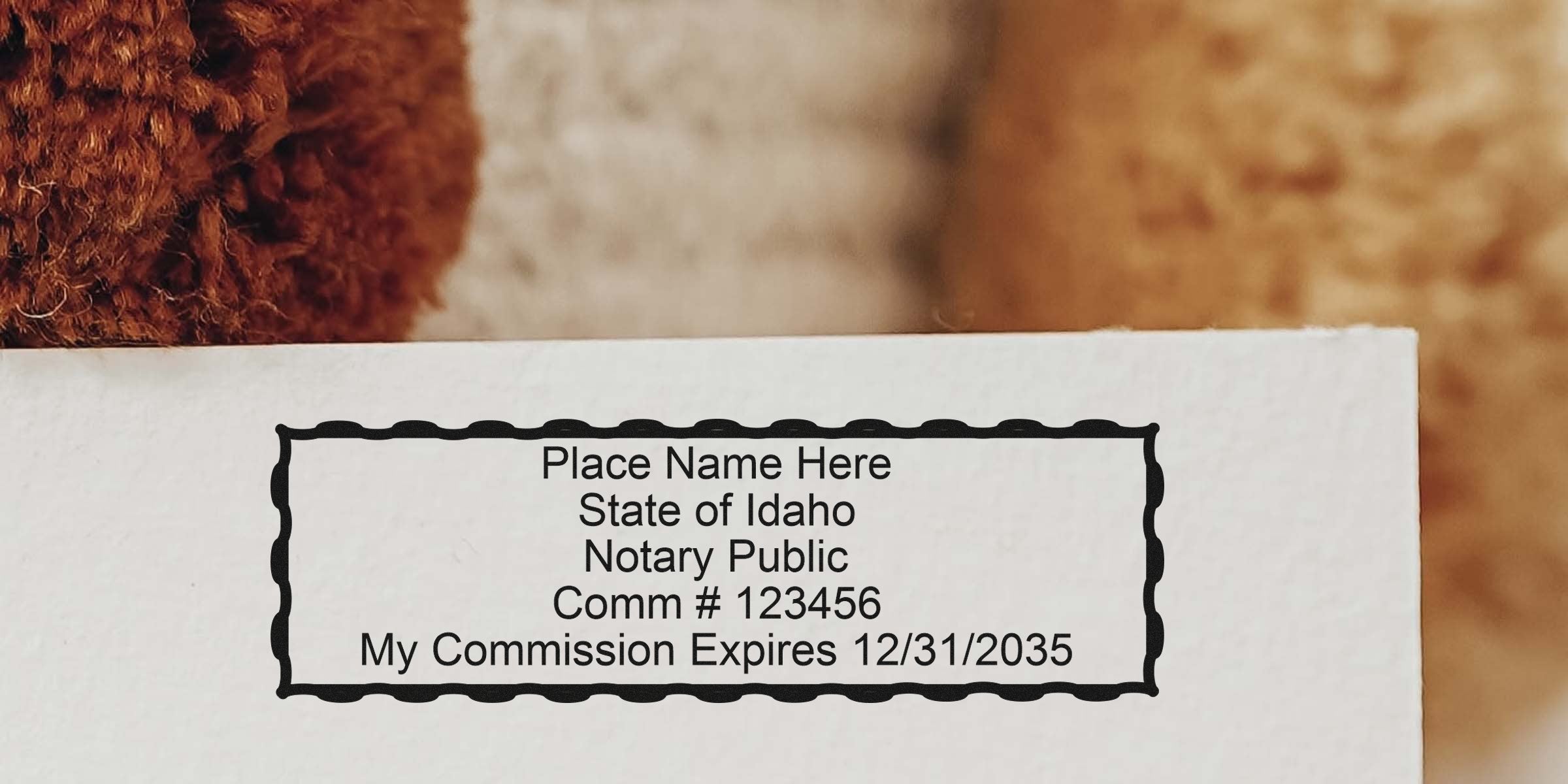 Idaho notary stamp on white paper showing commission number and expiration date, with a self-inking design.