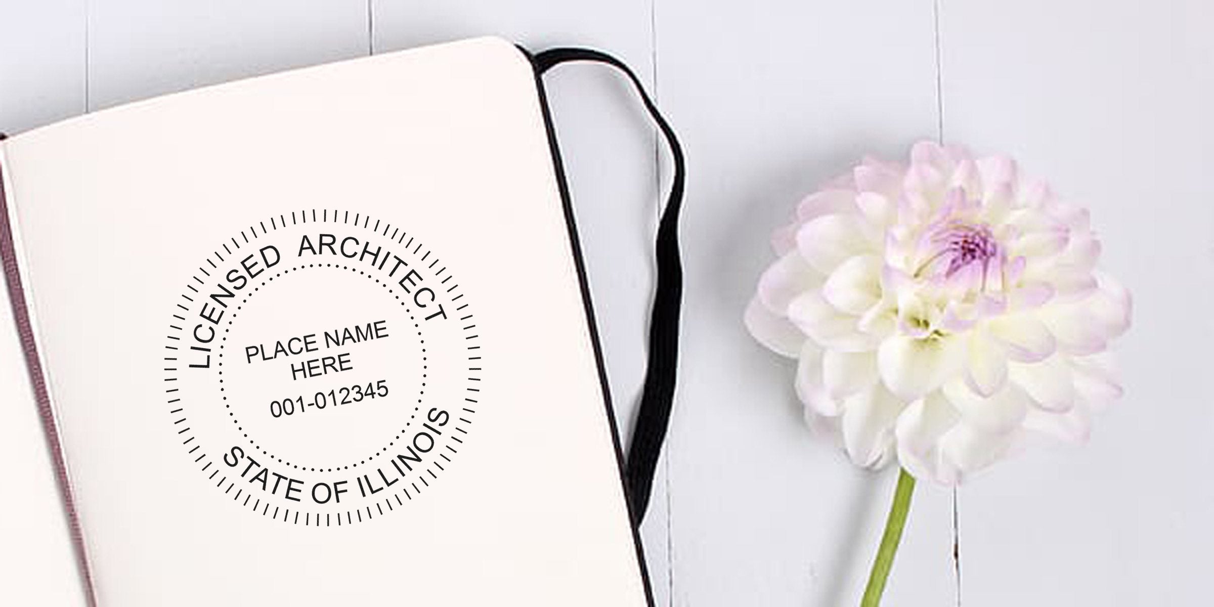 Illinois architect stamps an open notebook with a white flower on a wooden table, displaying creative stamp design ideas.