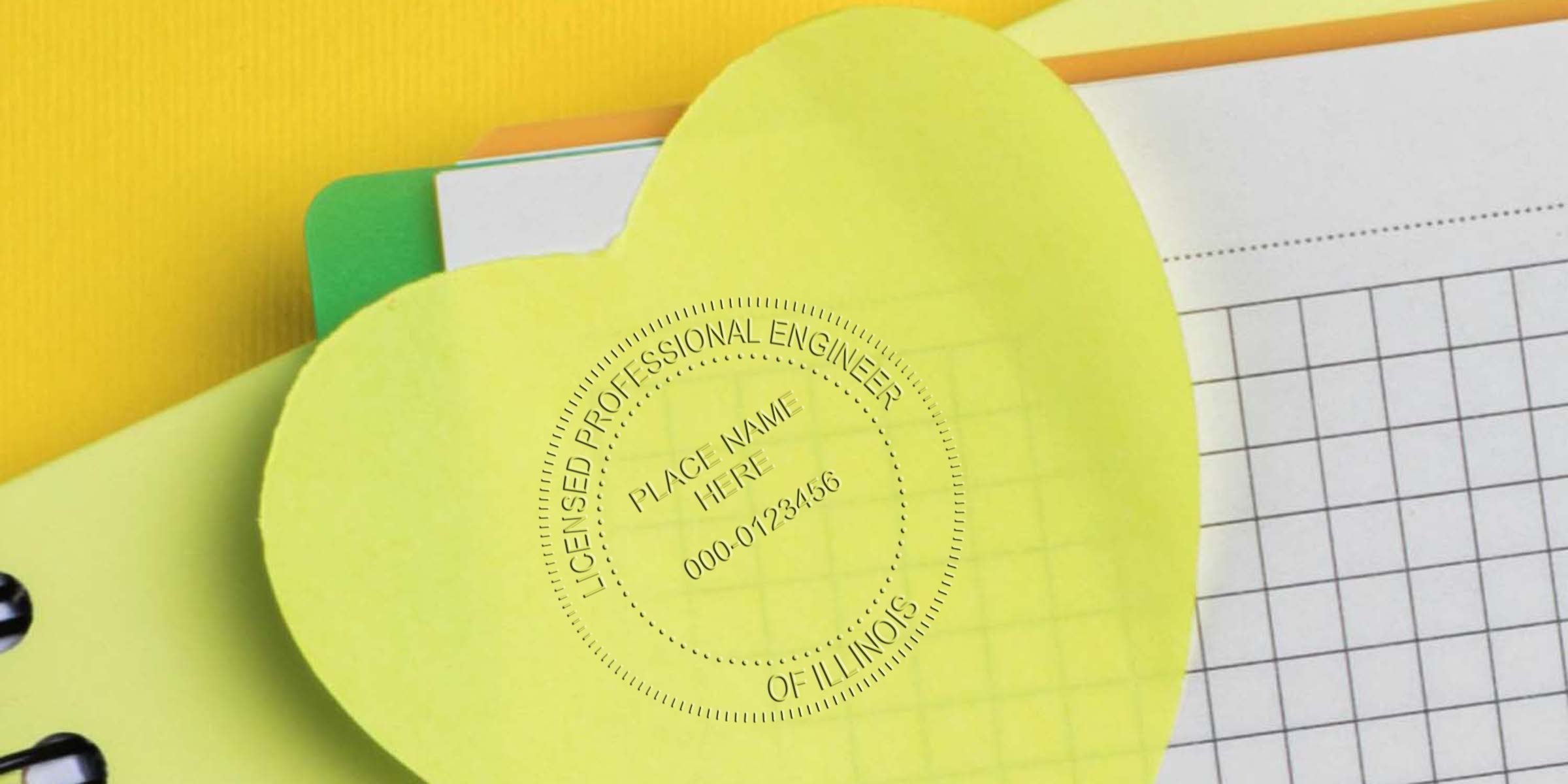 Illinois engineer seals a yellow heart-shaped Licensed Professional Engineer paper, surrounded by notebooks and grid paper, emphasizing the personal significance of engineer stamps.