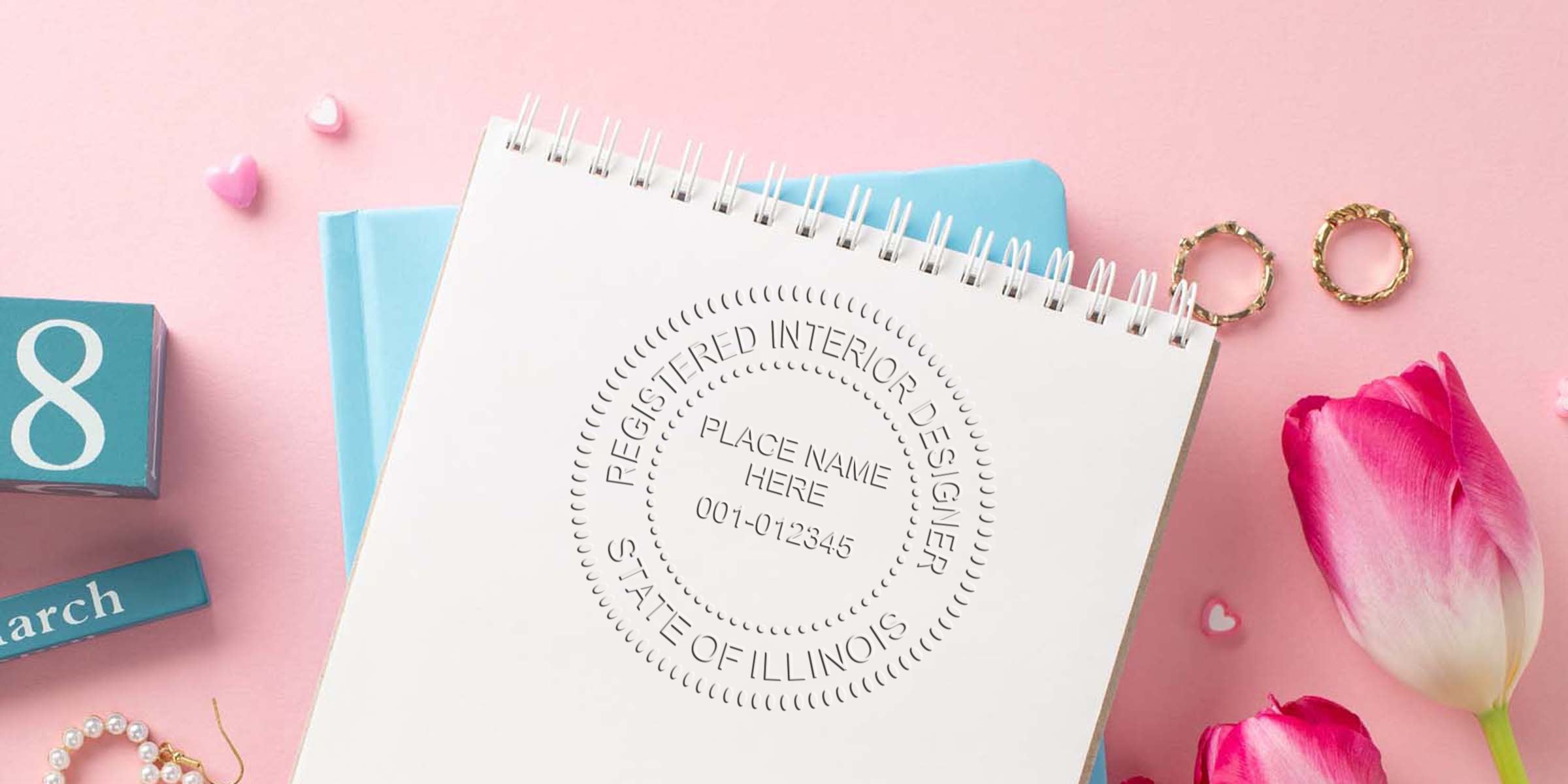 Illinois interior designer seal on notebook with pink tulips and March 8 calendar block, symbolizing interior design certification and regulations in Illinois.