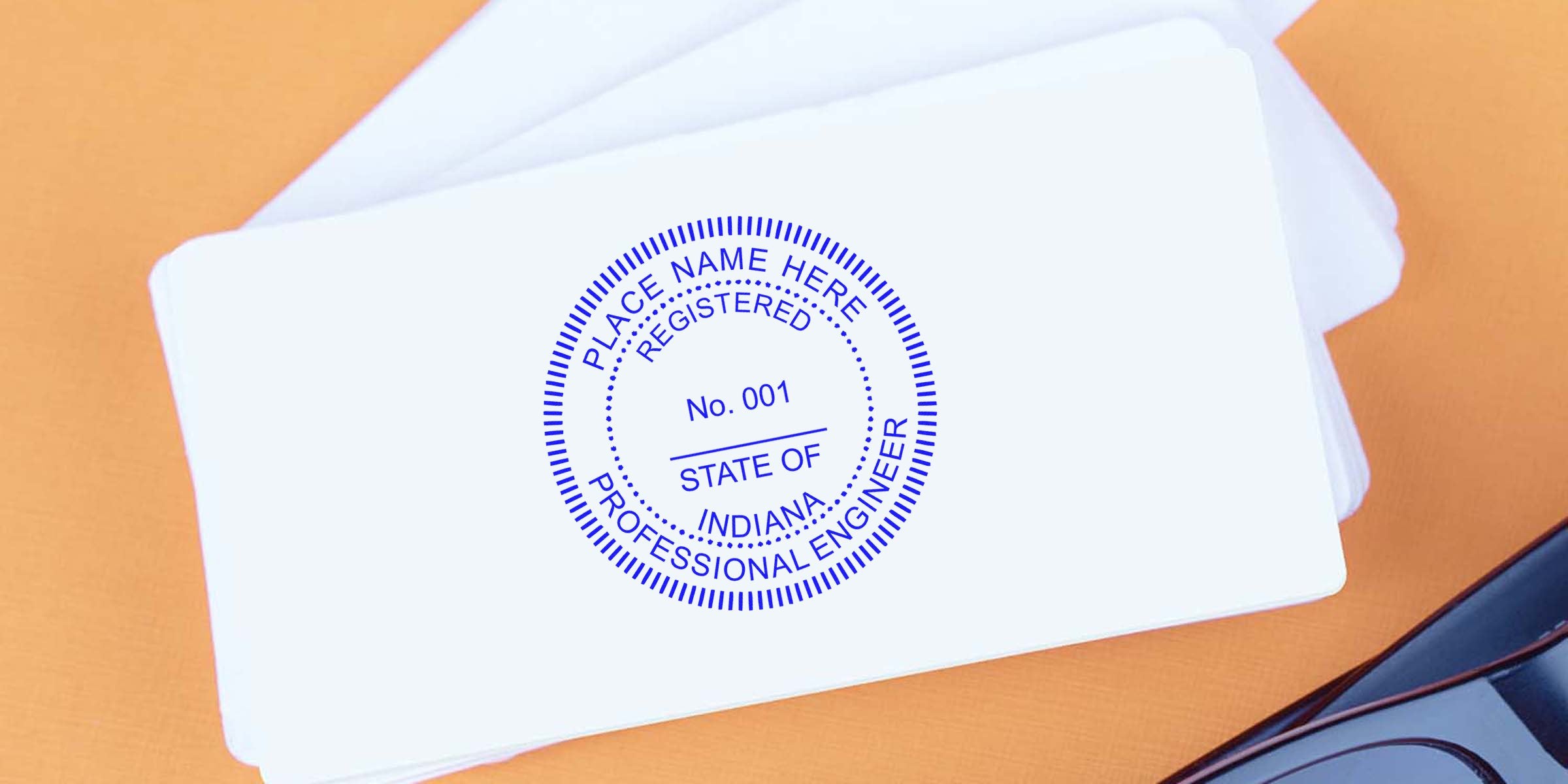 Indiana engineer stamp on white cards with glasses, emphasizing engineer stamp rules on an orange background.