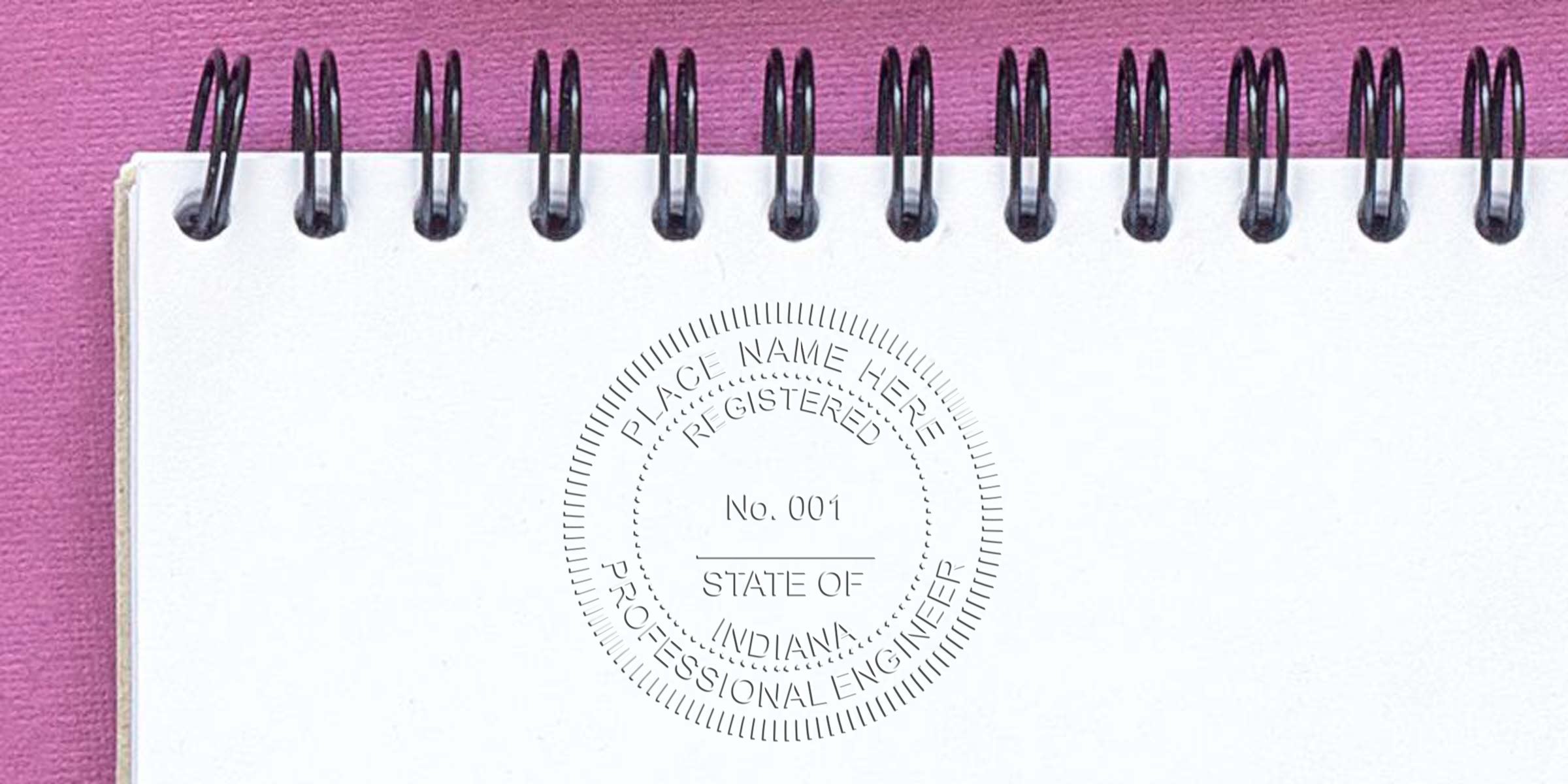 Professional Engineer Seal on white notebook with pink background, featuring Indiana Engineering Certification and Professional Engineer Seals.