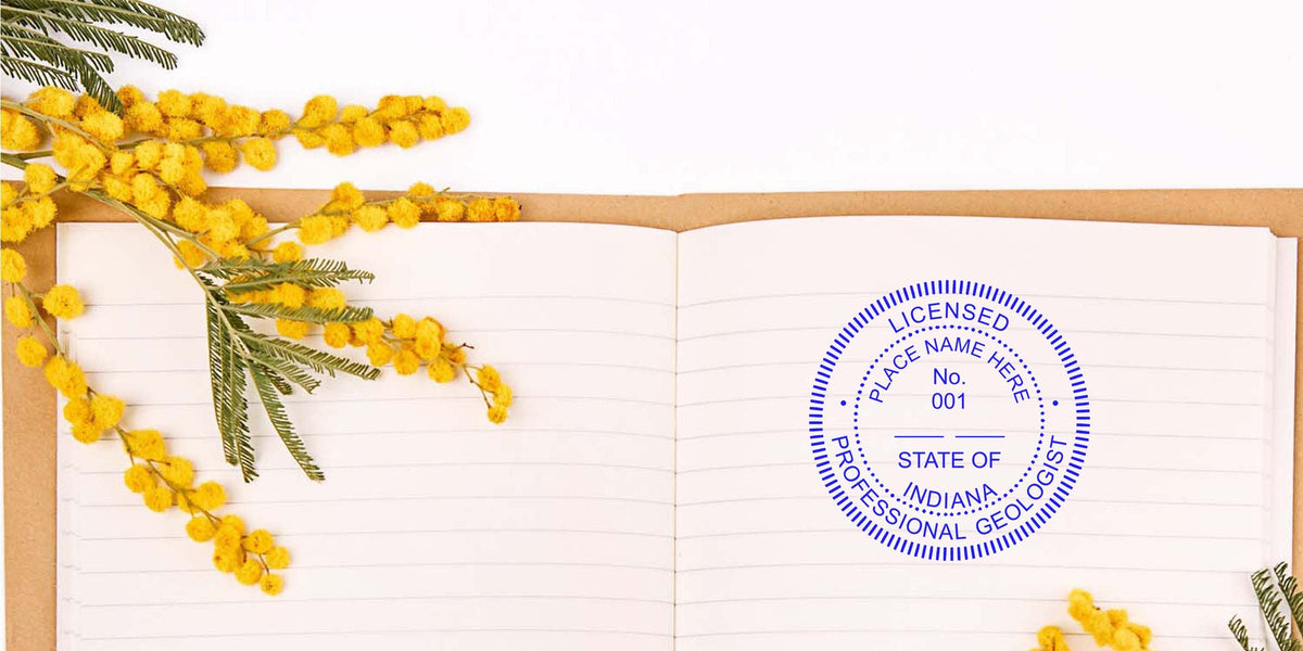 Open notebook with yellow mimosa flowers, an Indiana Geologist stamp, and Indiana Geologist licensing documents.