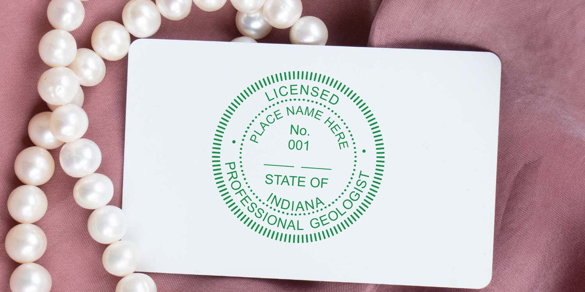Licensed professional geologist card with pearl necklace on pink fabric, featuring Indiana geologist stamp size and requirements.