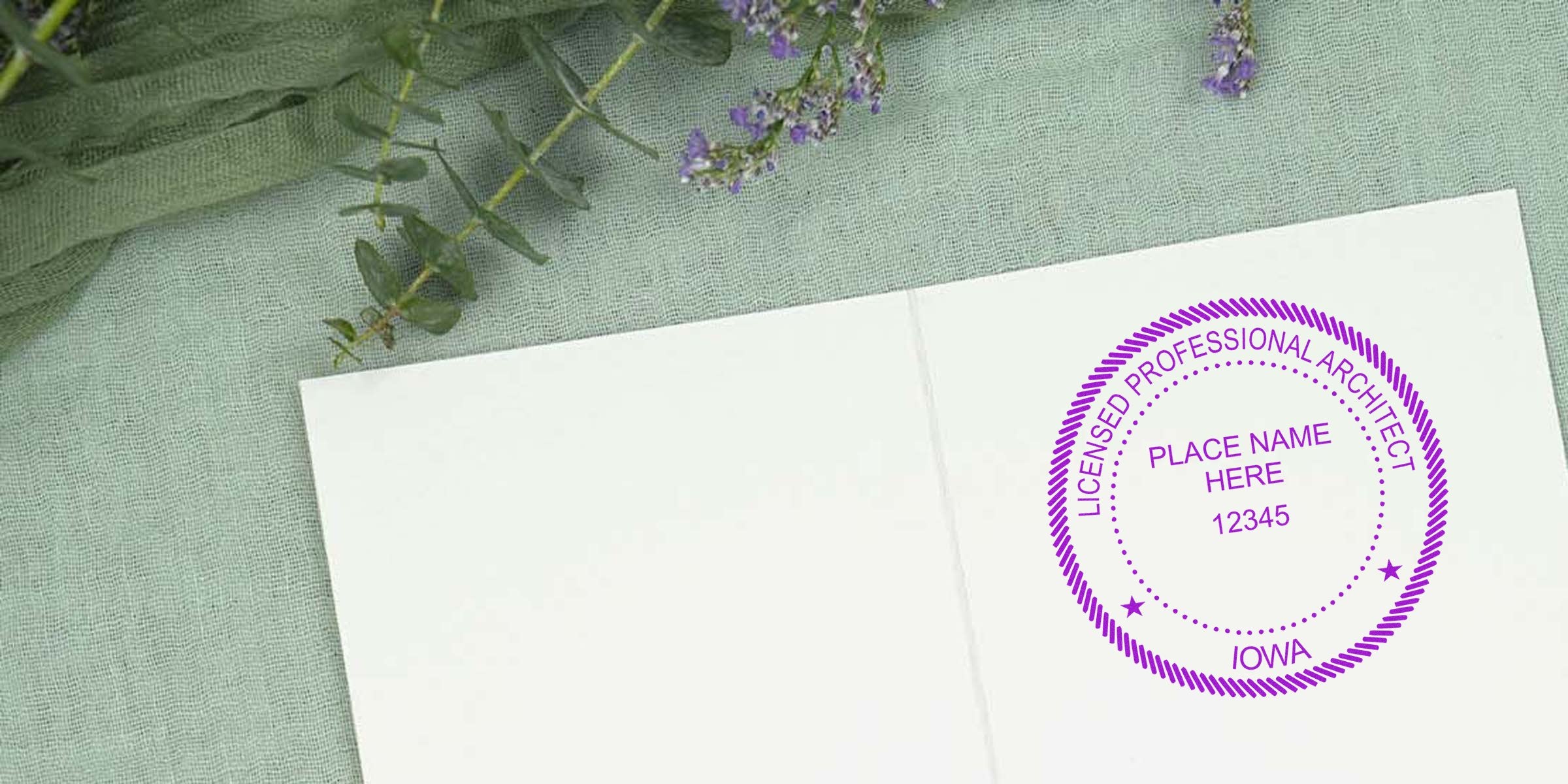 Iowa licensed architect stamp on white paper with green fabric and purple flowers, highlighting Iowa architect licensing and stamp regulations.