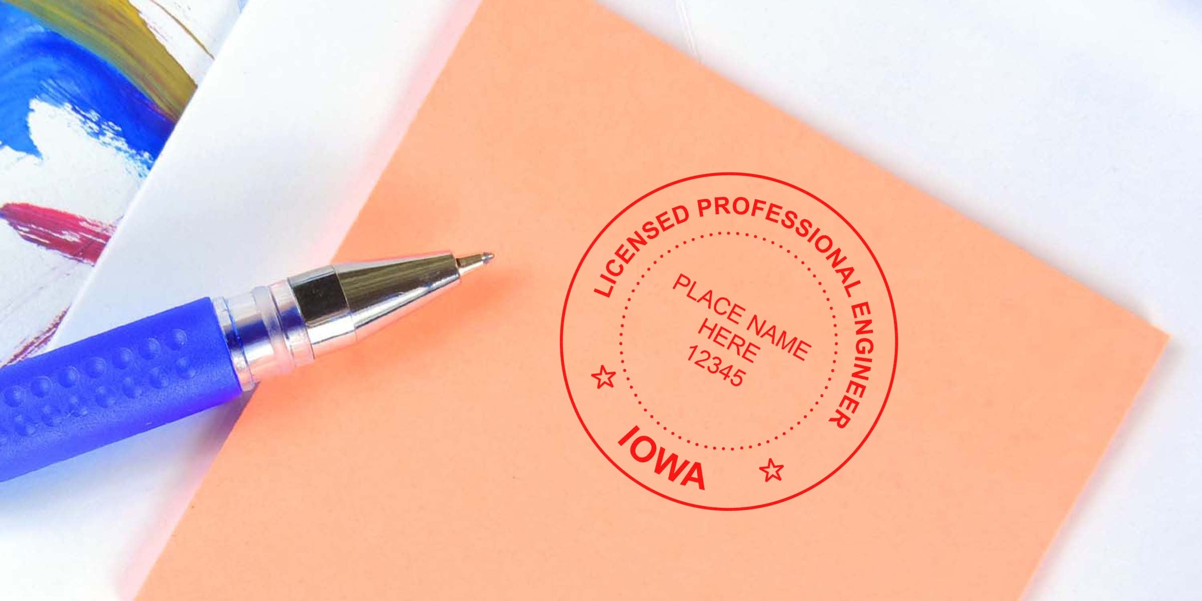 Licensed professional engineer stamp with Iowa seal on orange paper, showing blue pen engineer seal design and colorful painted background.