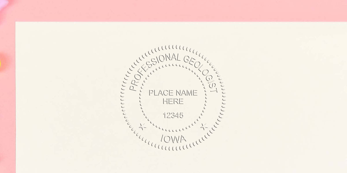 Custom geologist stamp with Iowa seal, place name, and license number on white paper background.