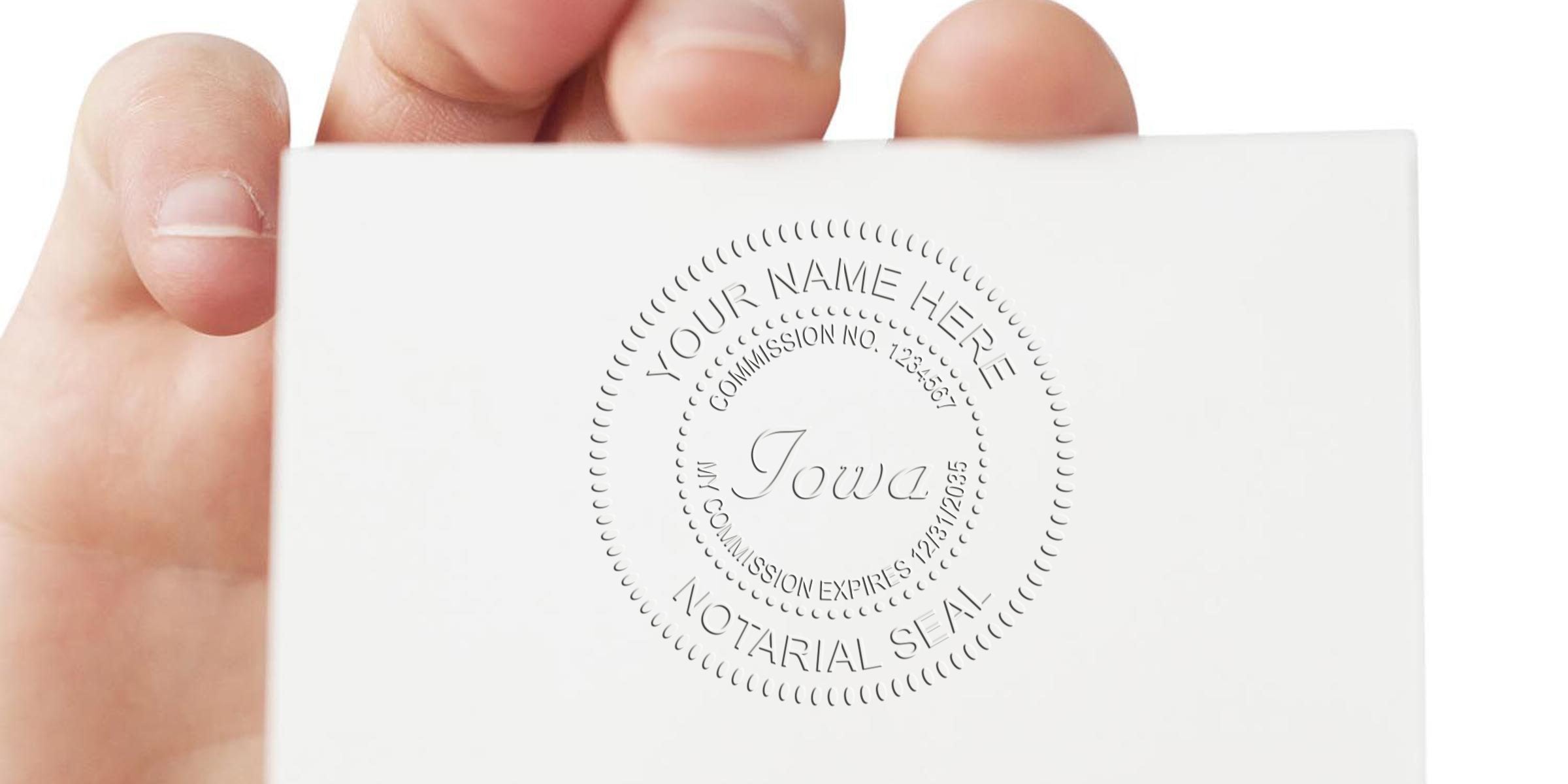 Hand holding IA notary seal on white paper, official stamp for selecting notary seal, commission verification, and legal document authentication.